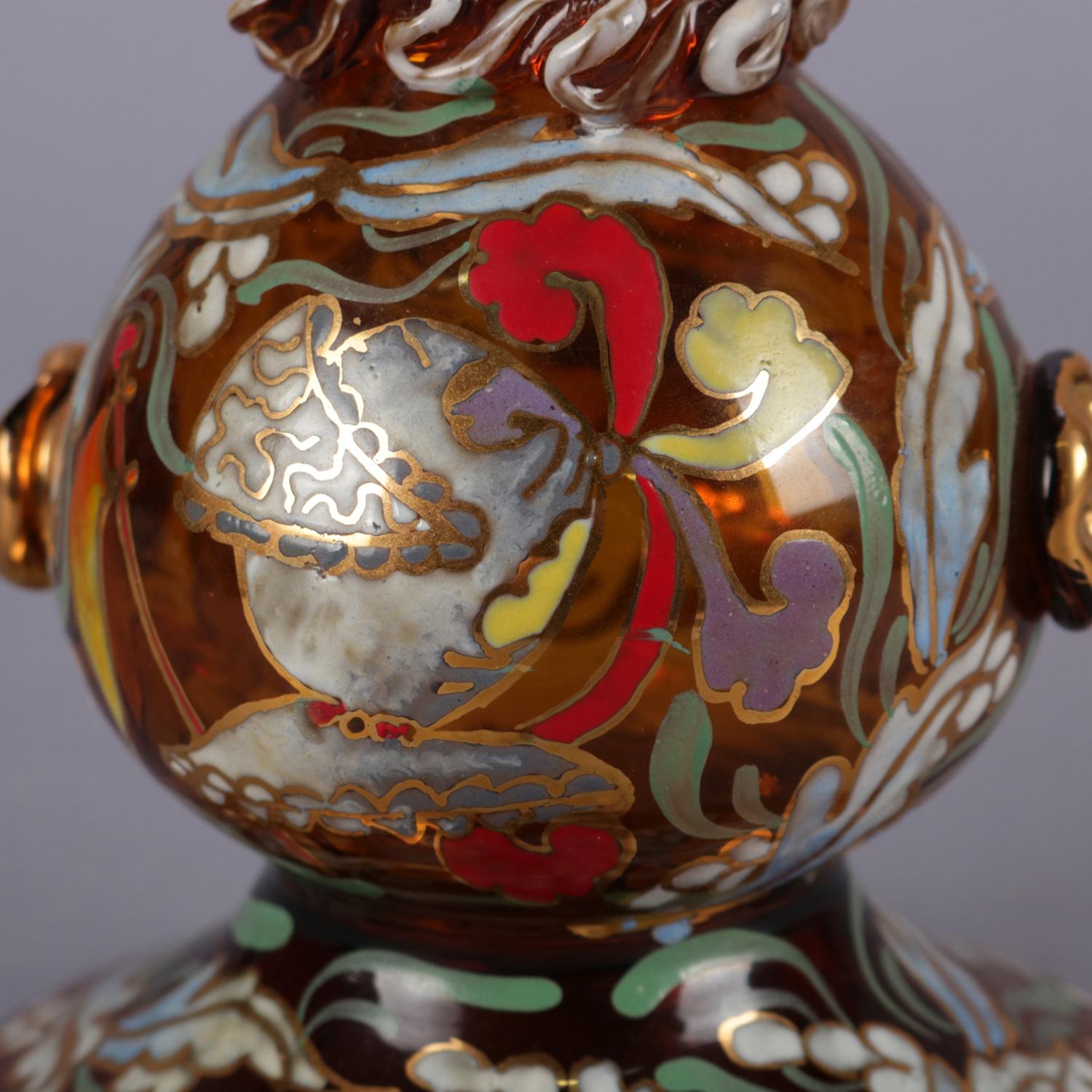 Antique Bohemian Moser School blown amber glass ewer features gourd form and Persian styling having hand painted gilt and polychrome decoration, stopper with figural swan finial and cork, circa 1890.

Measures: 16