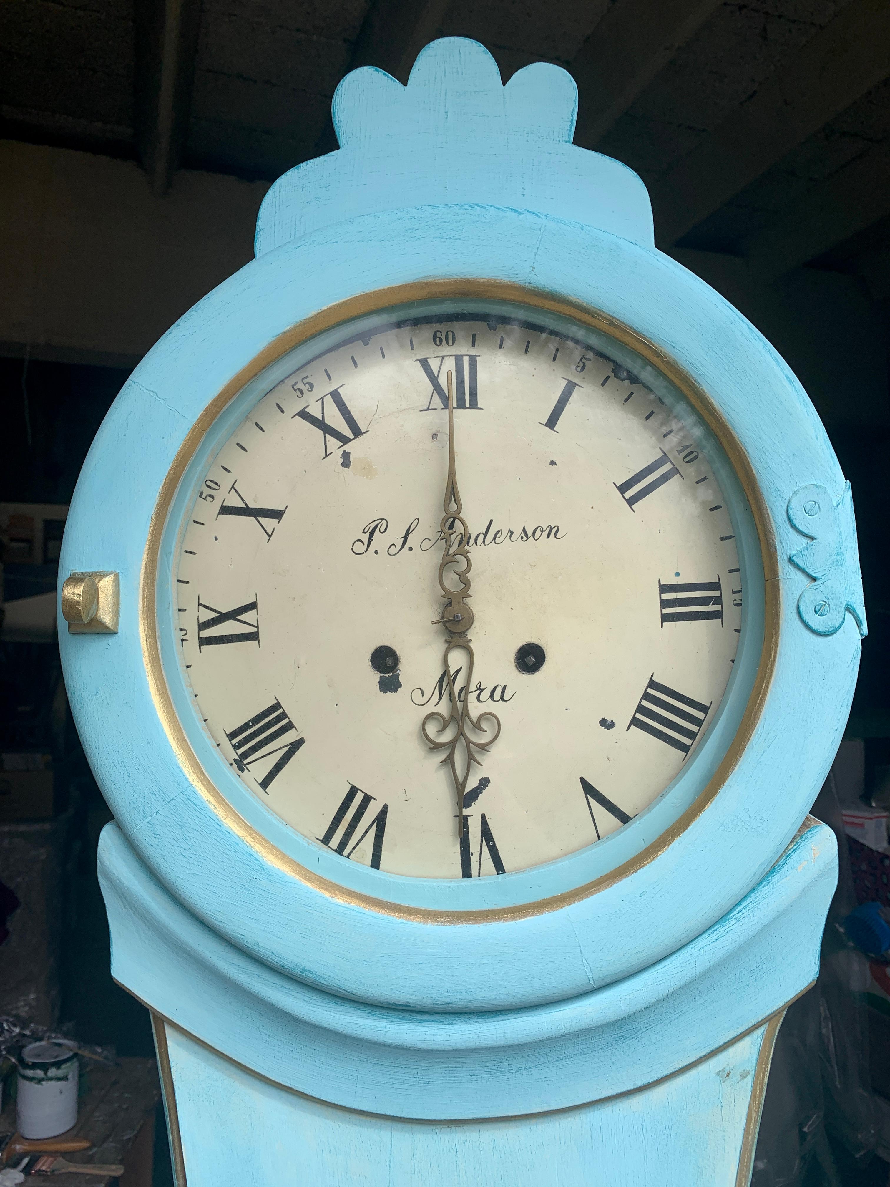 Antique Swedish mora clock from the 1800s in lovely Pale Blue finish and gold detailing with a simple shape body and a superb detailed roman numeral face with P J Anderson Mora initials in good condition. Measures: 210 cm.

It has the classic