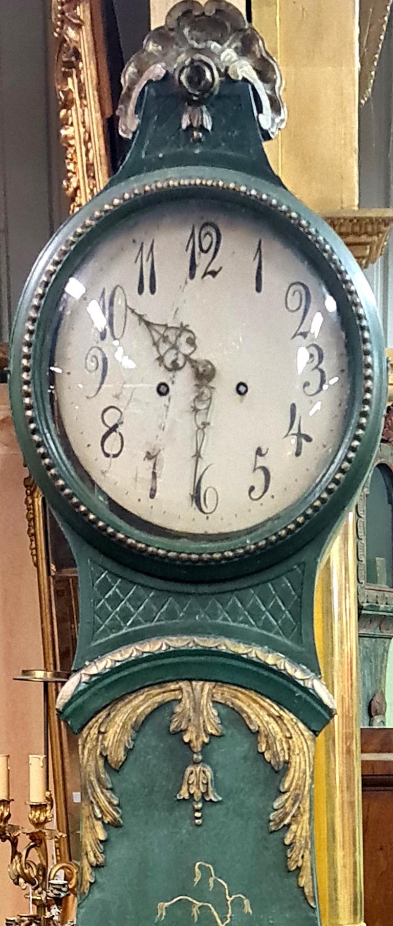 Antique Swedish Rococo mora clock from the late 1700s in lovely Green and Gold finish and amazing chinoiserie detailing with an extended belly shape body, Rococo crown and detail and a clean face in good condition for its age. Measures: 220 cm.

It