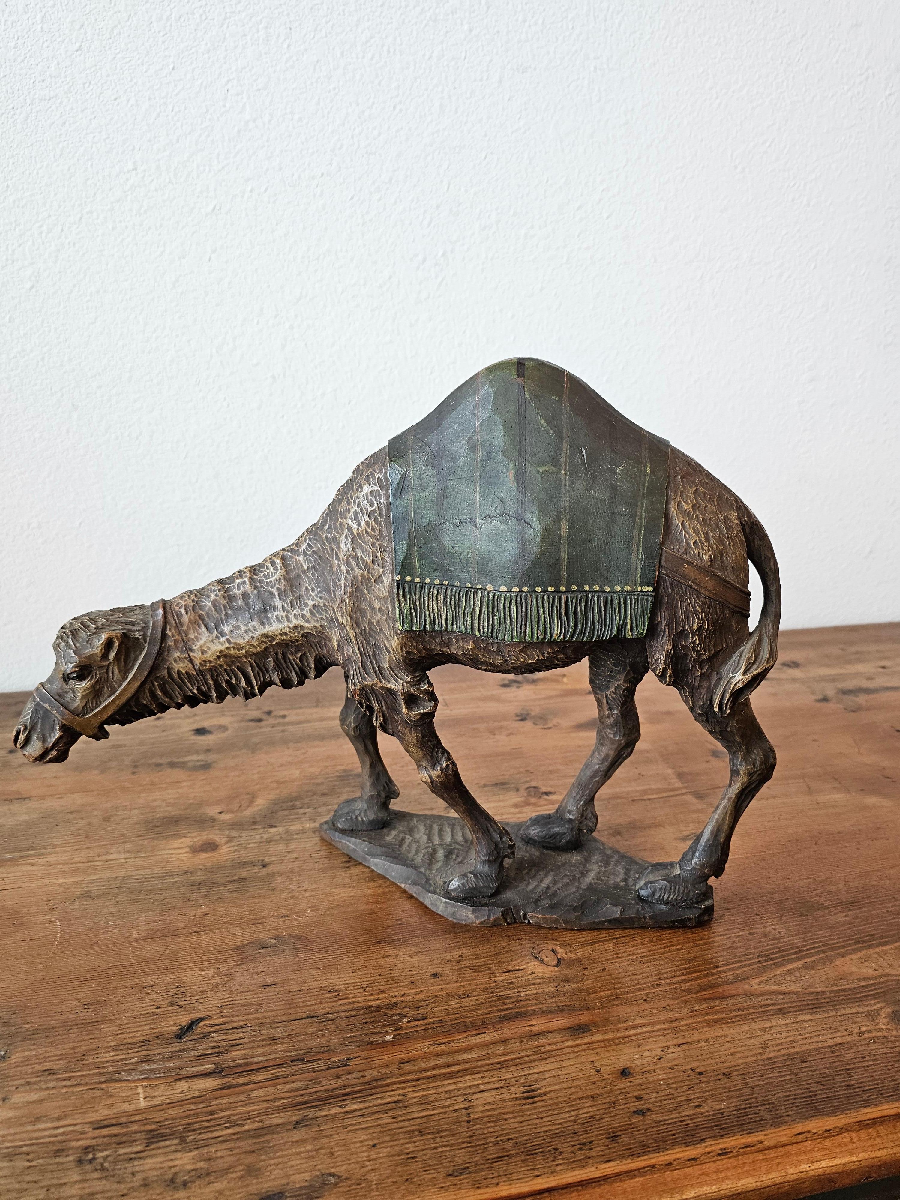 A superbly carved camel statue, early 20th century, Morocco, exceptionally executed, the North African Art Deco Orientalist figural carving features fine detailing throughout, hand carved, sculpted and painted, the naturalistic rendering depicted