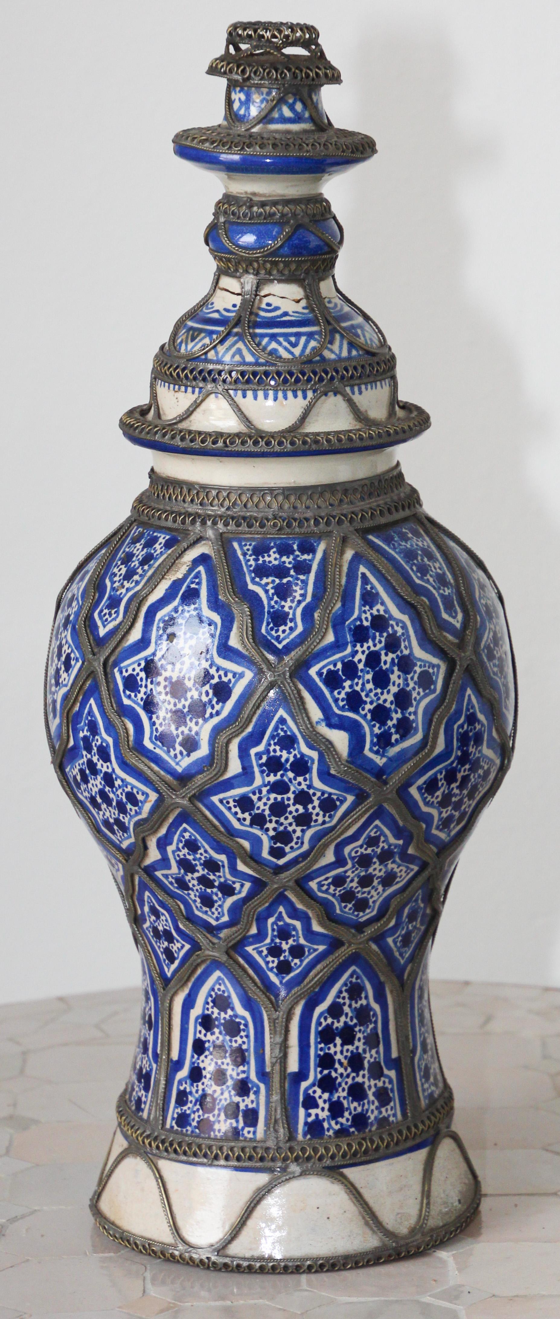 Fabulous handcrafted antique Moroccan blue and white ceramic candle holder in Moorish style.
 Adorned with fine filigree silver nickel work.
Candlestick with white and blue color of the ceramic is renowned as bleu de Fez.
Handcrafted in Fez,