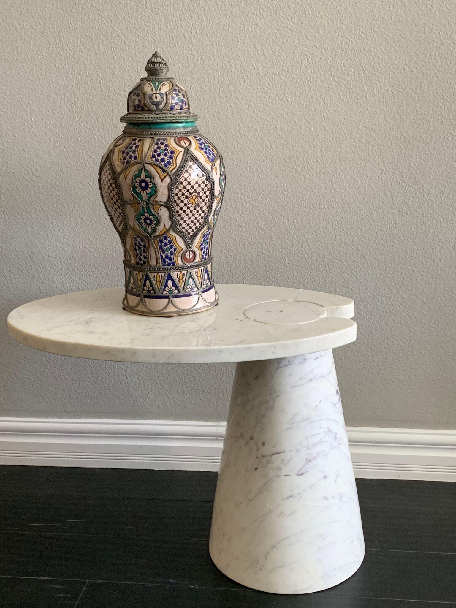 An absolutely gorgeous antique Moroccan vase from Fez. This vase features intricate nickel filigree and hand painted blues, teals and yellows. It's in great antique condition with wear and a heavy patina.

This lidded vase is truly a gorgeous hand