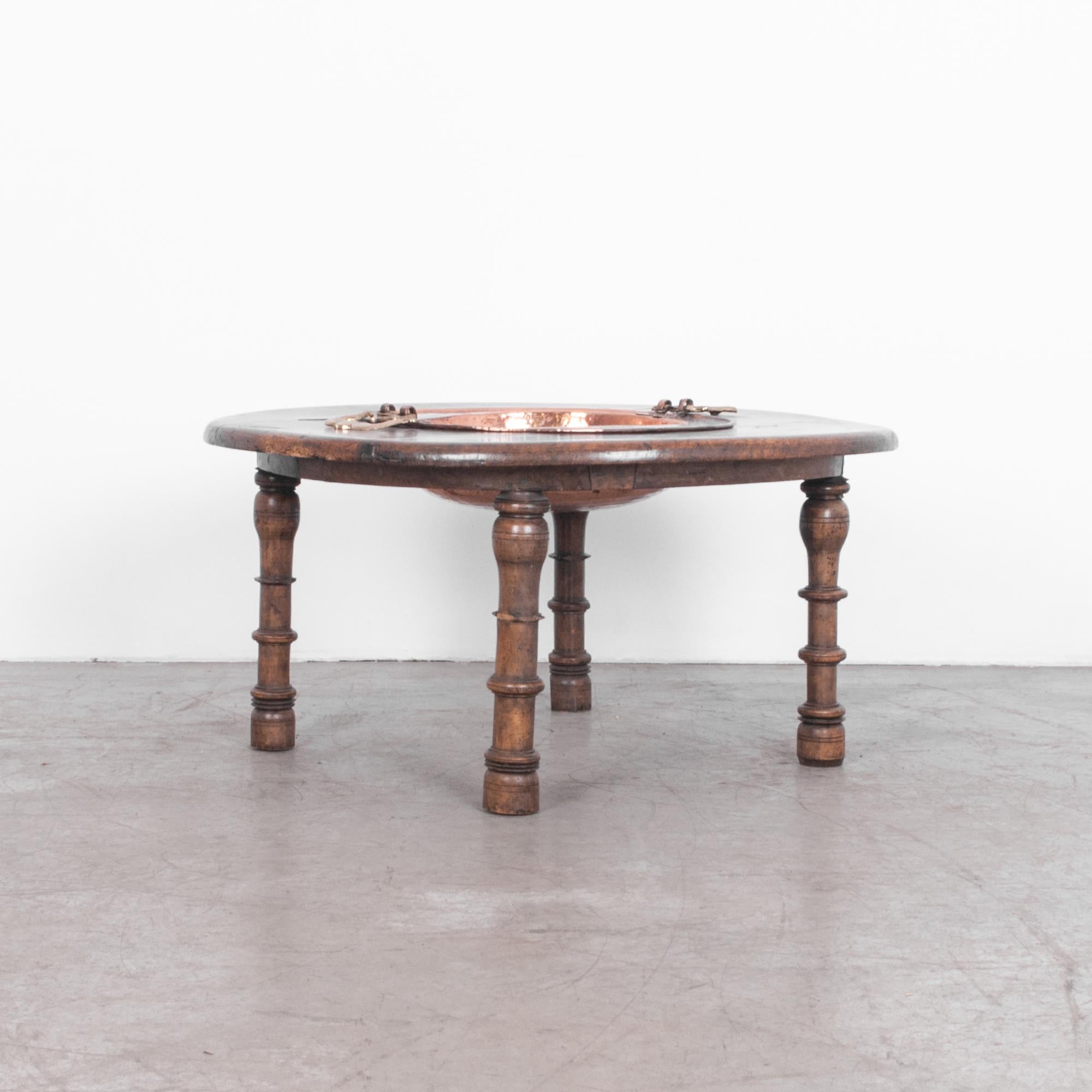 A late 19th  century Moroccan couscous table.  Couscous originates in North Africa, served as a house warming one pot dish, and a central part of life. With turned legs, rustic top, and removable hand beaten copper bowl, this is an exemplary