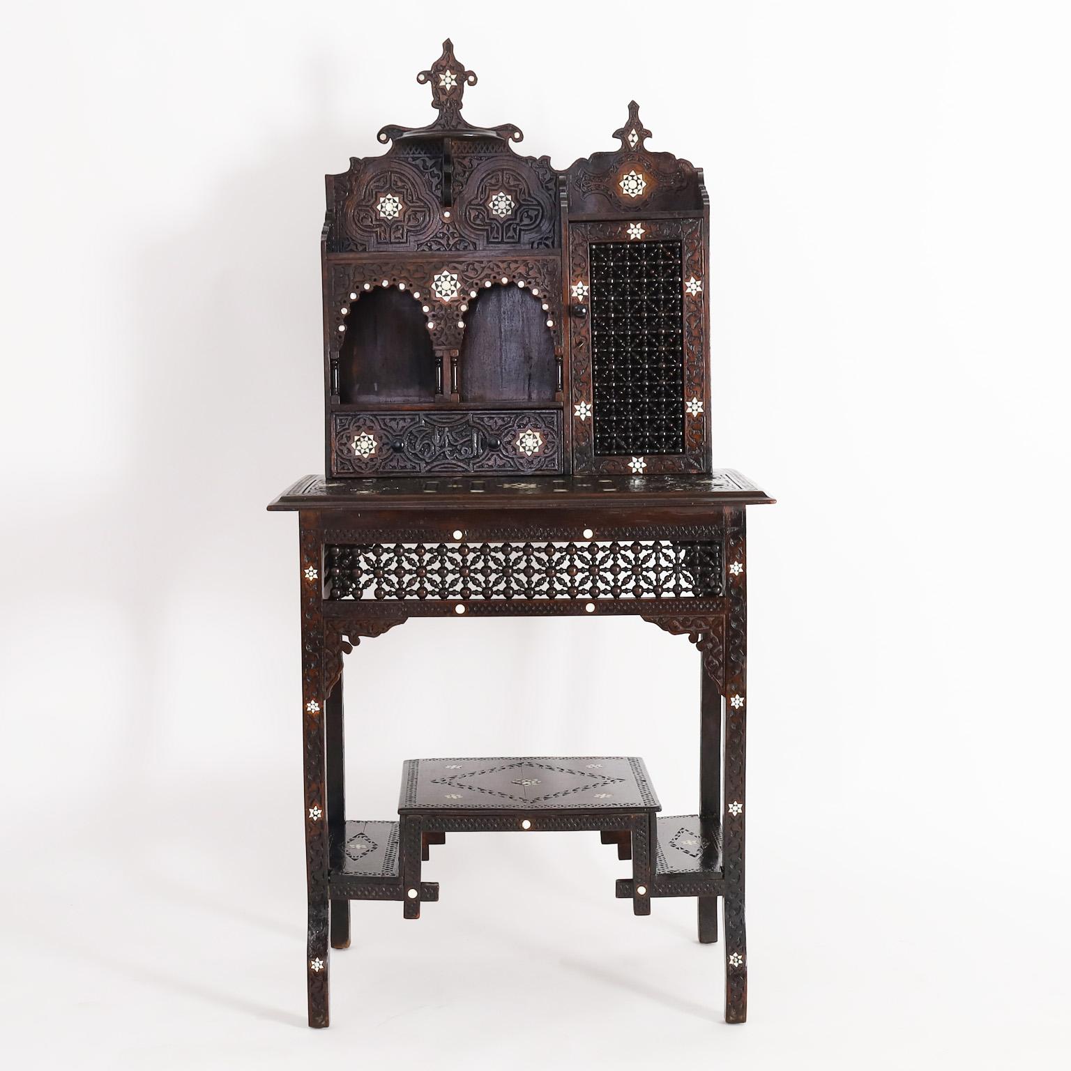 Important 19th century Moroccan escritoire or desk crafted in mahogany with strong aesthetics movement influences. Featuring Moorish architectural references, floral and geometric bone inlays and carvings throughout, including arched niches with