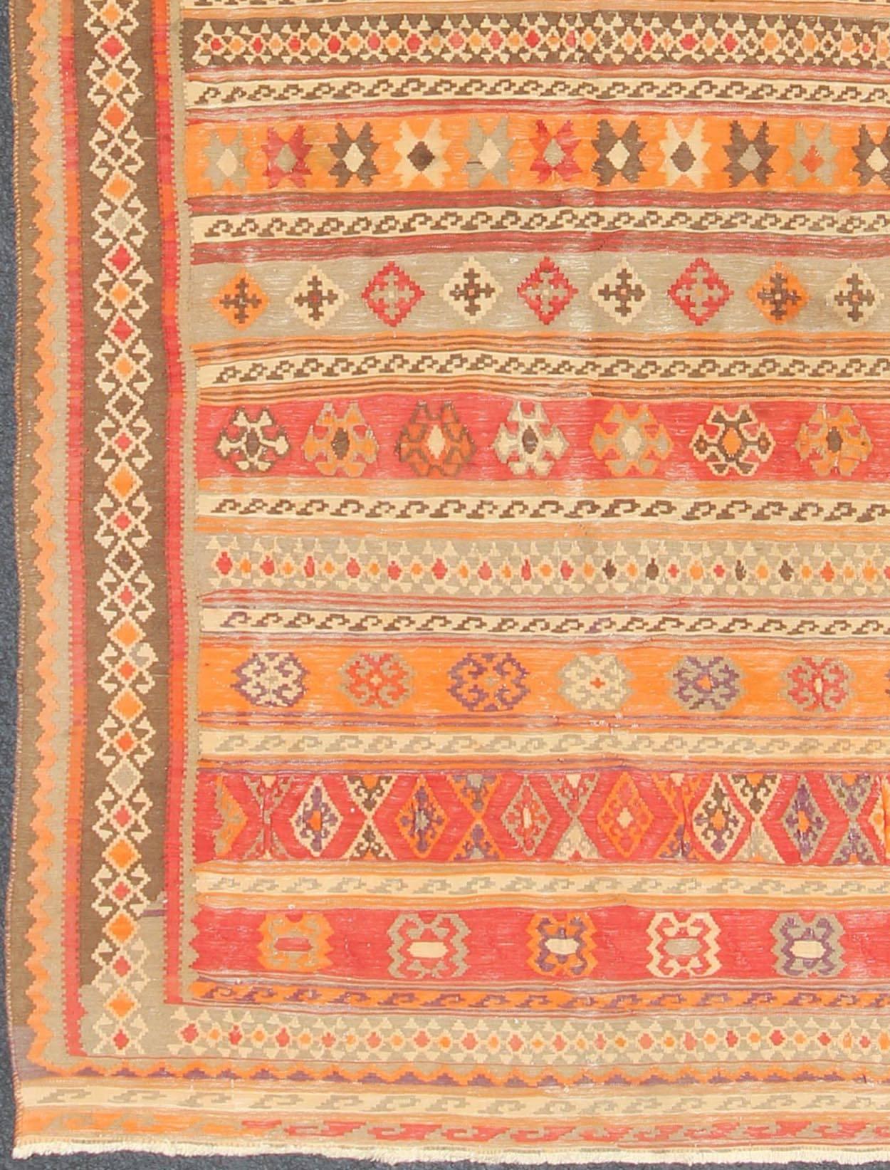Antique Moroccan Kilim with Embroidery in Red, Orange, Gray and Brown, S12-0601, 1930's Antique Moroccan Kilim Rug . 
This brilliant kilim displays faded orange-red, yellow, red, brown and gray stripes. The embroideries and details include panels of