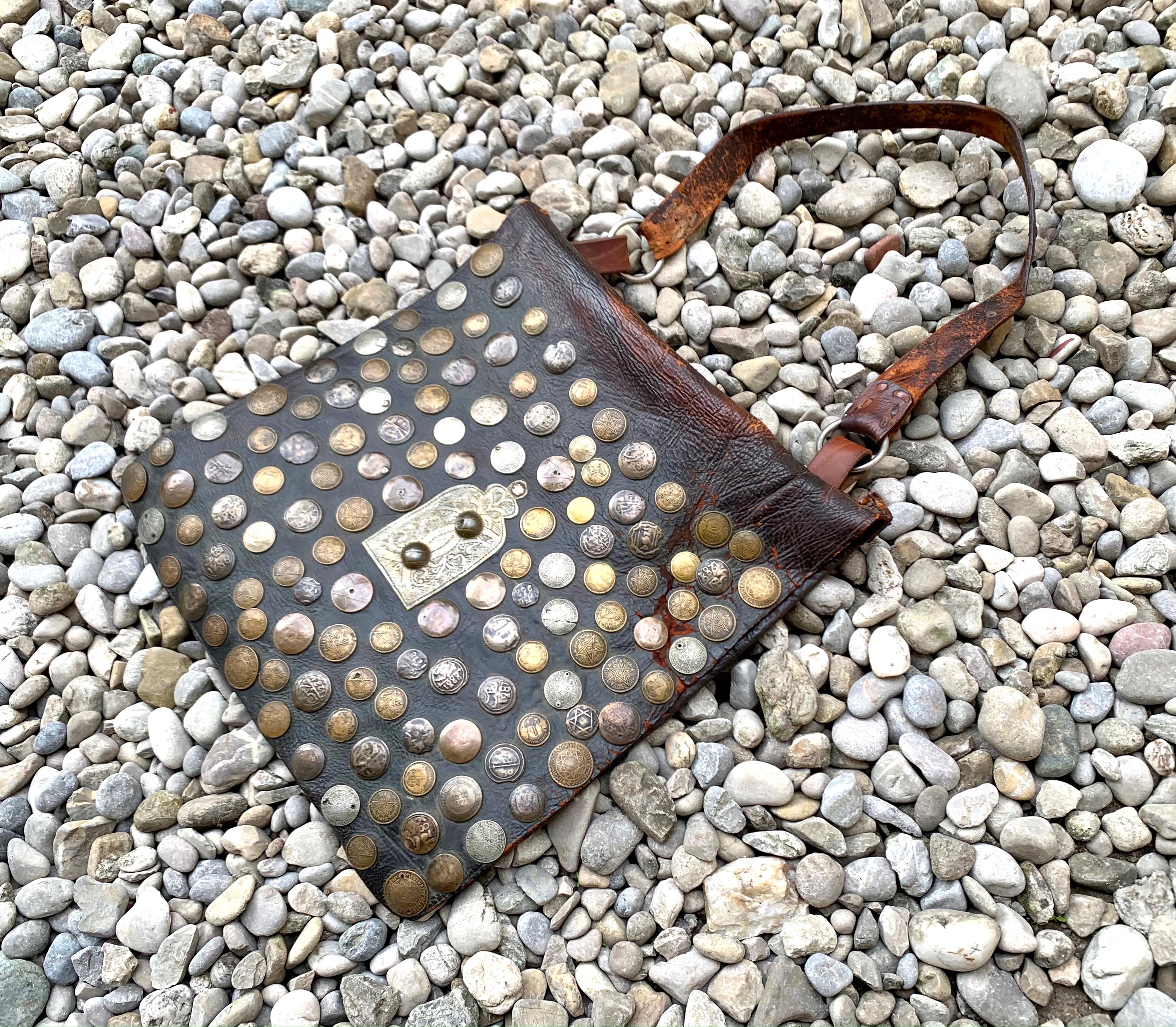 This magnificent leather bag is covered on it's front entirely with old coins,
As has often been the case with this kind of bags, the strap might have been replaced in the course of it's long working live.