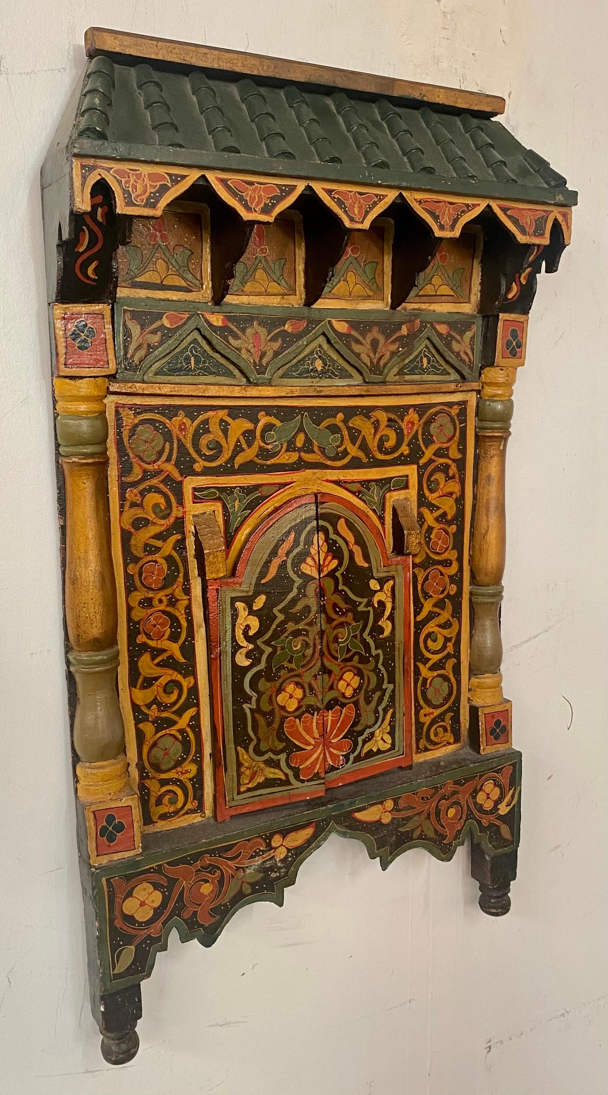 An antique Moroccan moorish hand painted and wood carved door design wall decor, sculpture or mirror frame. Featuring exotic and intricate geometrical motifs reminiscent of the glorious moorish architecture and style, the wall decor door style frame