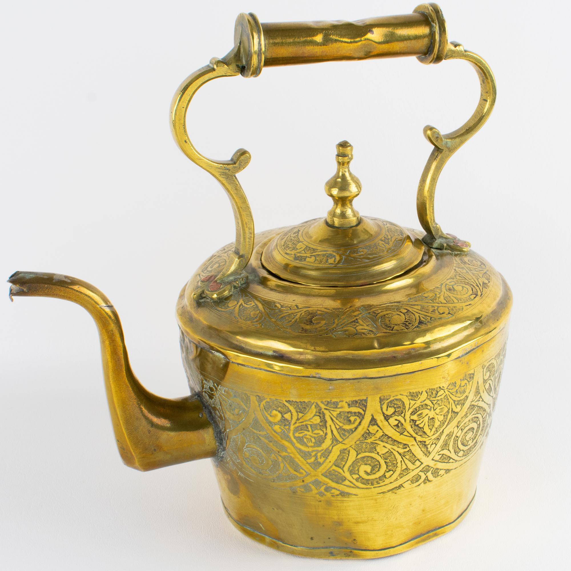 This antique brass tea kettle, meticulously handcrafted in the late 19th century, is a remarkable example of traditional Islamic metal artistry. Originating from Morocco, the piece showcases exquisite craftsmanship, with its surface richly