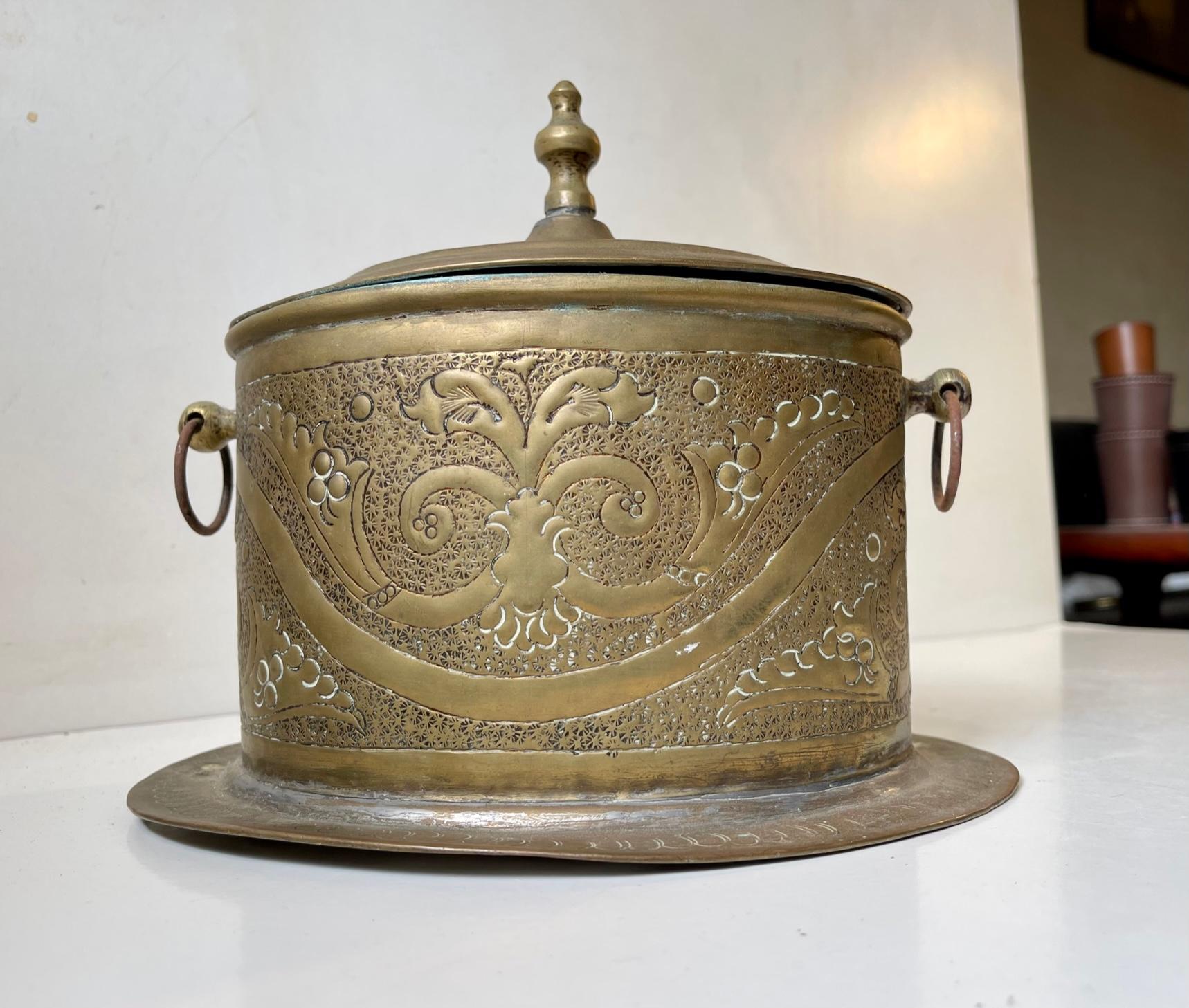 Late 19th or early 20th century Teacaddy in Hand engraved and embossed brass. Great rich patina that along with its details give it a certain charm. It has a hinged lid that works just fine. Unknown Moroccan makers mark present. Measurements: