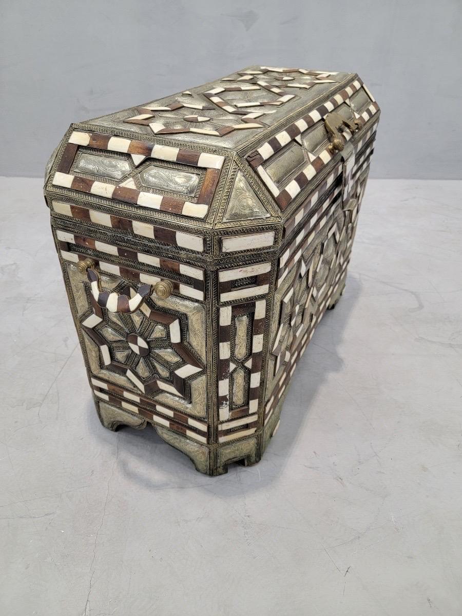 Antique Moroccan Wood Inlaid Bone & Hammered Metal Leather Lined Storage Chest

Inlaid with bone and adorned with hammered metal, this antique Moroccan chest is a magnificent decorative art piece that will bring a unique charm to your space. Its
