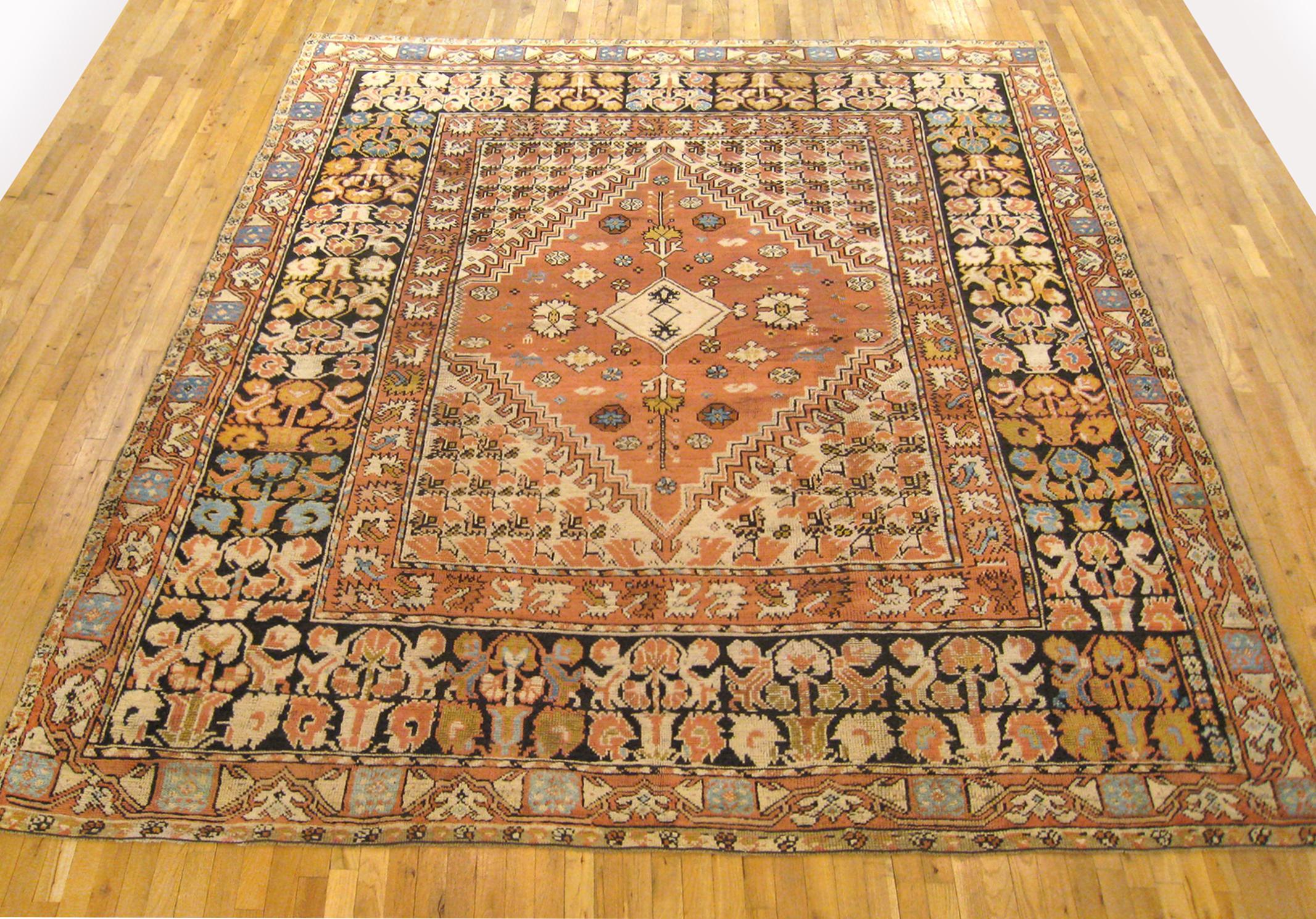 Antique Moroccan Rug, circa 1920, Room size. 

A one-of-a-kind antique Moroccan Rug, hand-knotted with medium thickness wool pile. This beautiful rug features a central medallion design on the rose primary field, within a black outer border. In