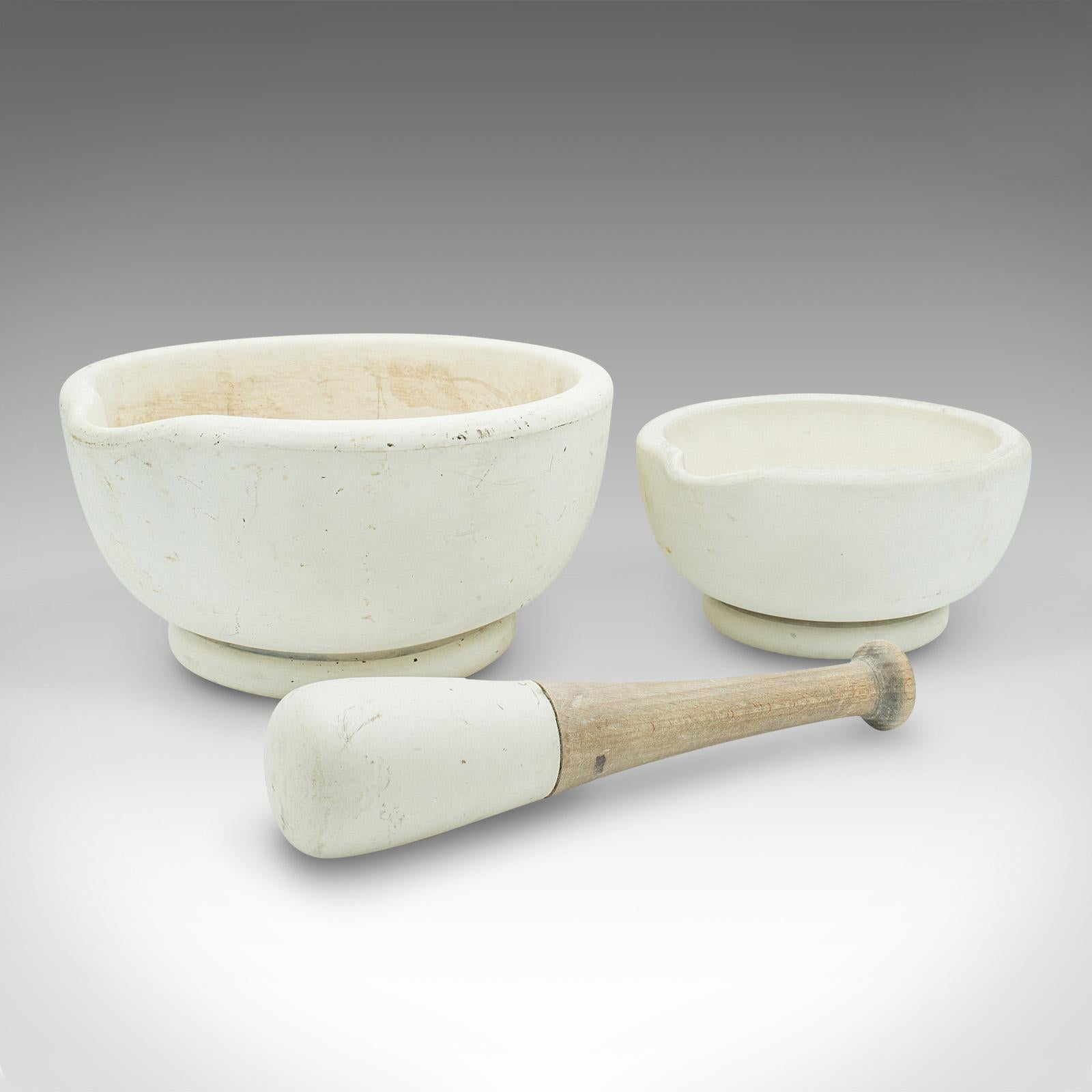 This is an antique mortar and pestle duo. An English, ceramic and beech apothecary or cookery aid, dating to the late Victorian period, circa 1900.

Of great proportion, across two generous mortar bowls
Displaying a desirable aged patina with
