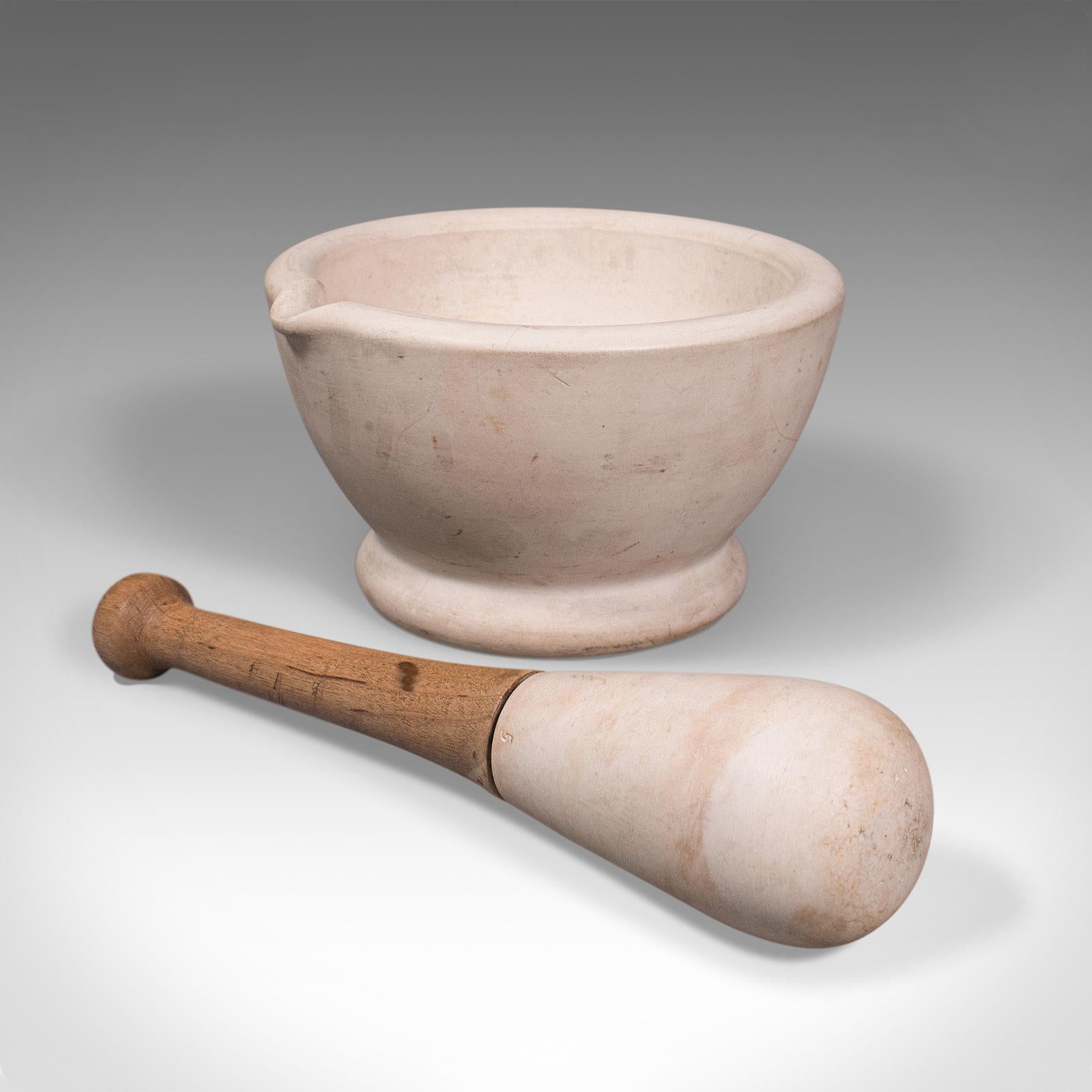 This is an antique mortar and pestle. An English, ceramic and beech apothecary or cookery tool by Wedgwood, dating to the late Victorian period, circa 1900.

Beautifully presented grinding tool, reassuringly heavy.
Displays a desirable aged