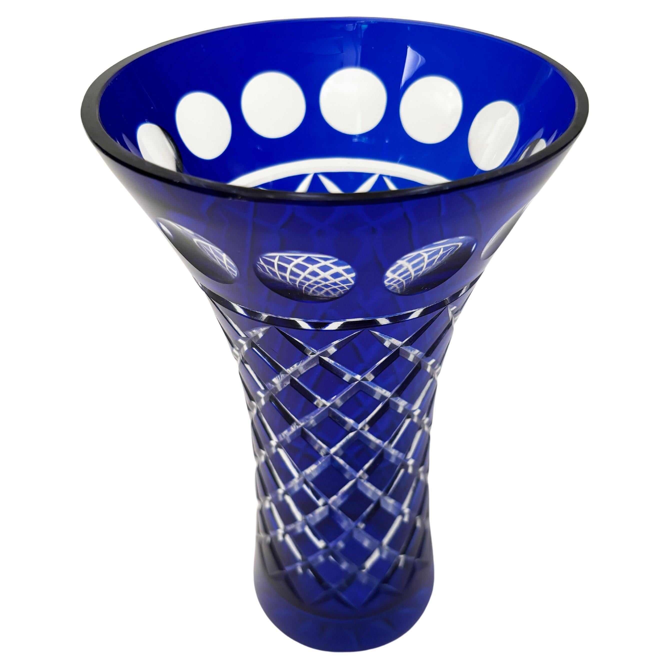 This stunning cobalt blue crystal Moser Bohemian vase is created using a cobalt blue cut to clear glass method that creates spectacular effects. The circular patterns, coupled with the diamond cut body, all on a beautifully curved vase makes this a