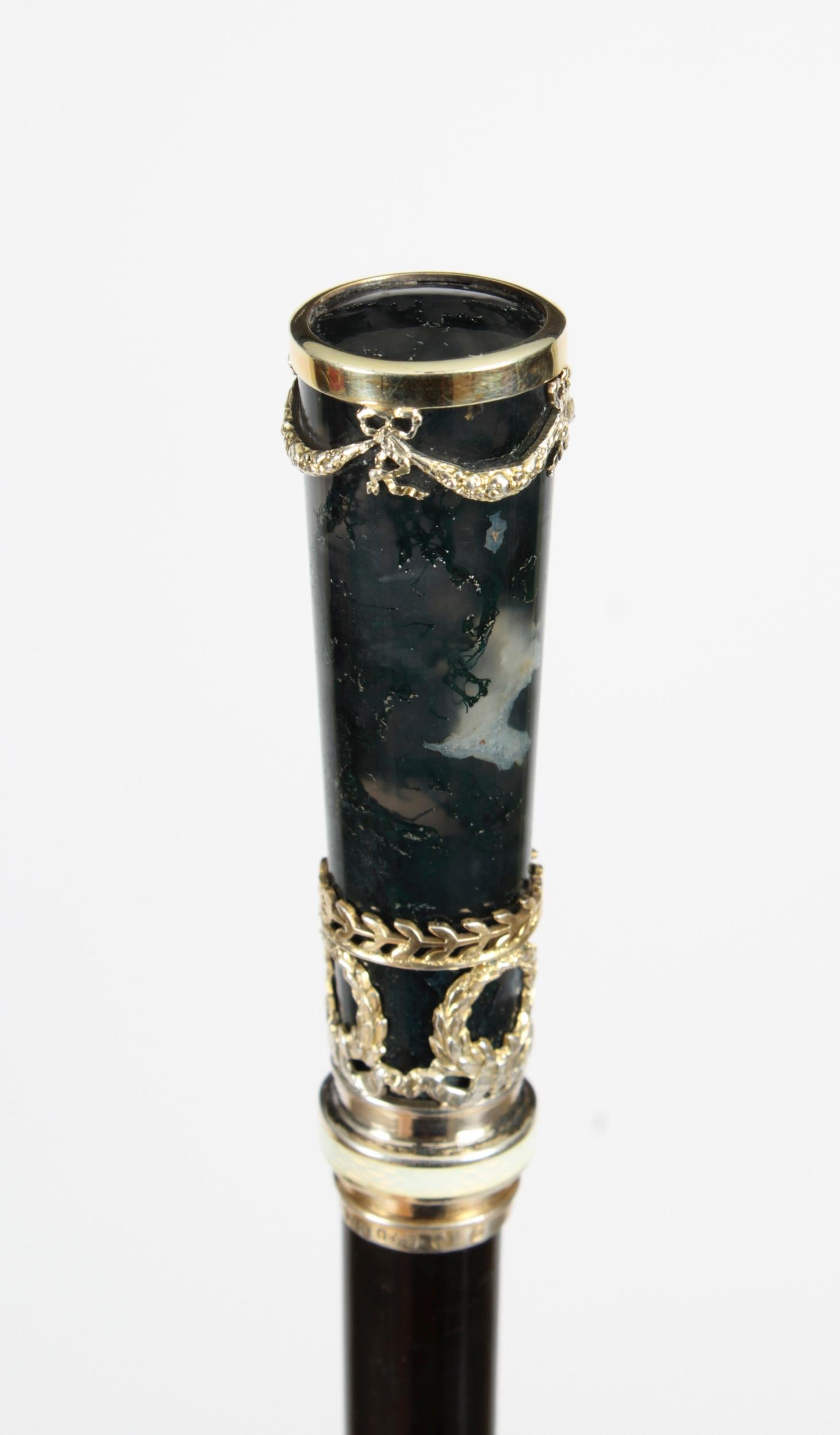 This is a superb Austrian Neoclassical Revival Moss Agate, Guilloché Enamel and sterling silver-mounted ebony lady's walking stick, hall marked for George Adam Schied, Vienna, and dated 1900.
 
This decorative walking cane features a slender