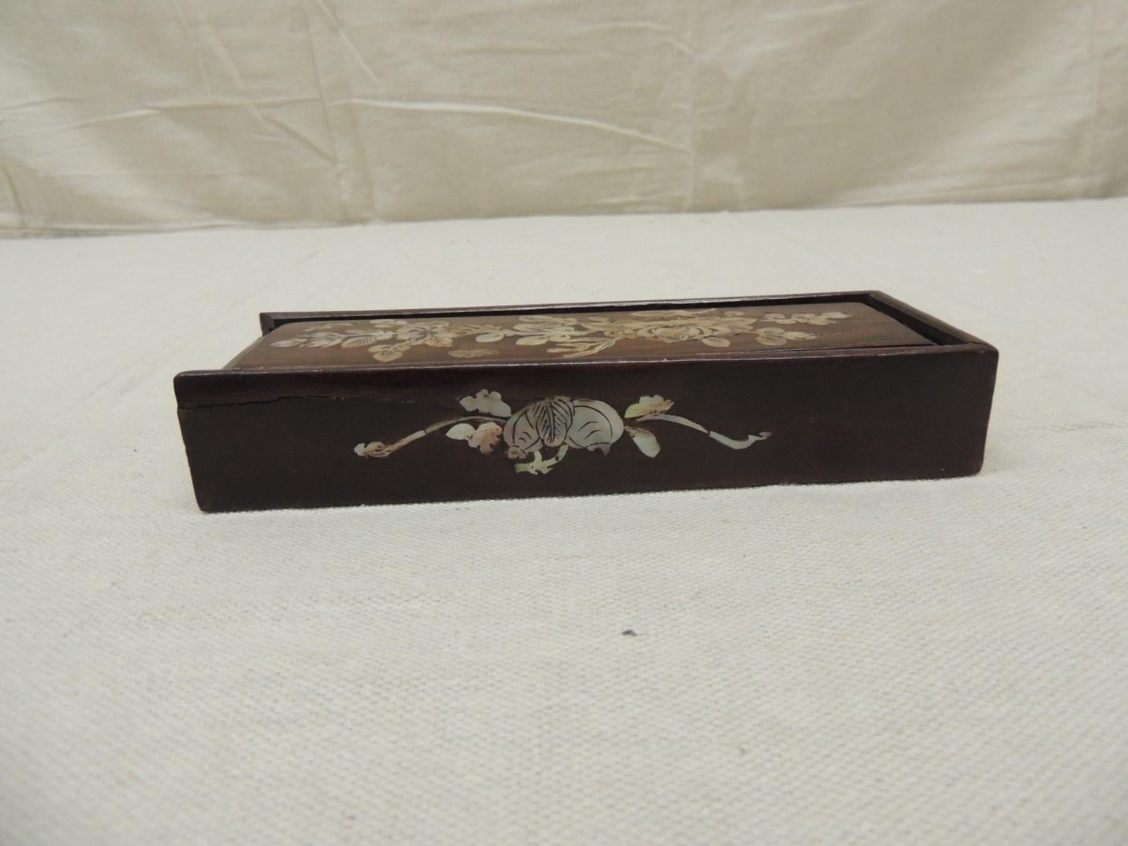 Antique mother of pearl and wood decorative box.
The cover open by sliding the top to the side.
Size: 7.5” L x 2.5” W x 1.25” H.