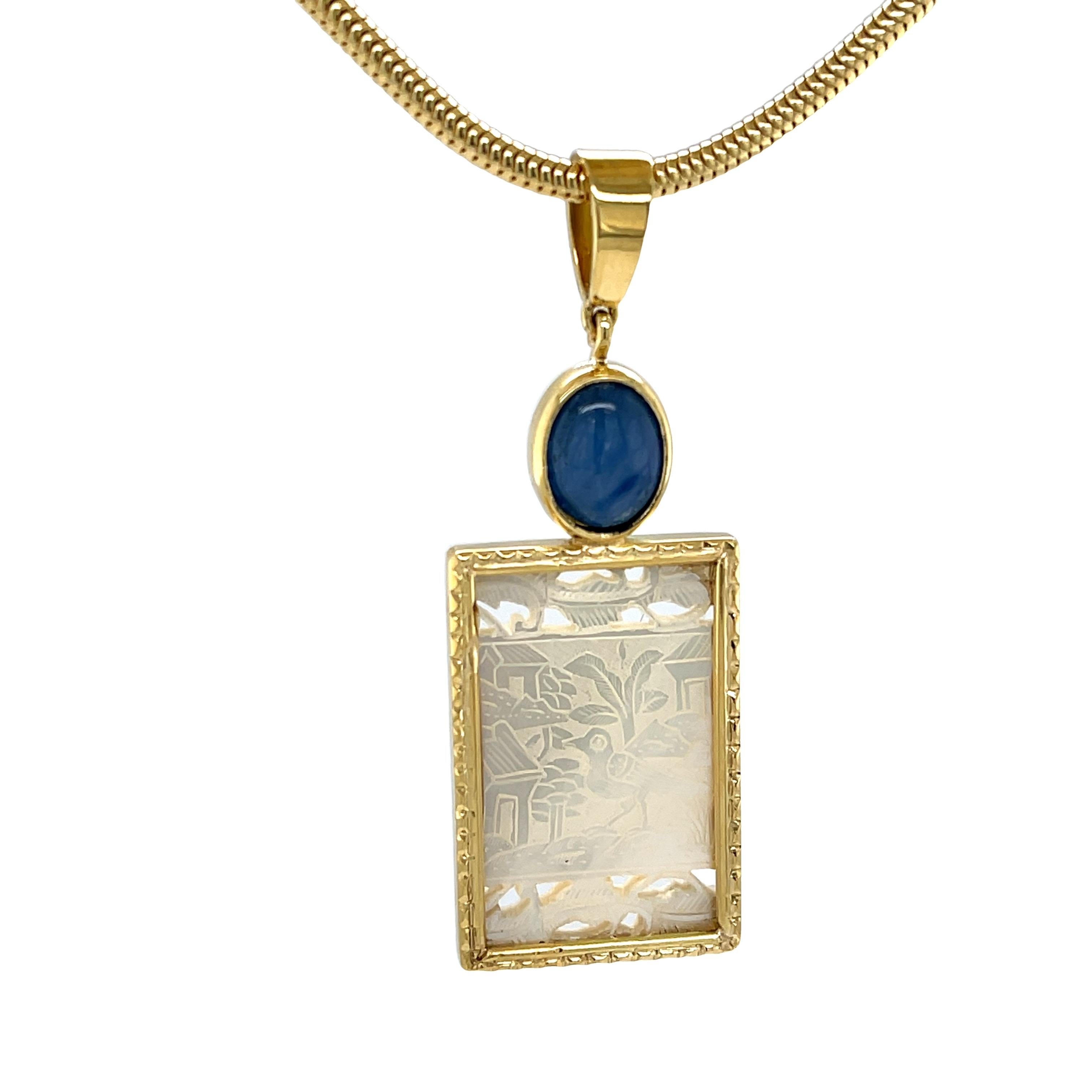 This stunning pendant features a beautifully fretted antique mother-of-pearl gambling counter set in precious 18k yellow gold, accented with a rich blue kyanite cabochon. Gambling counters, or gaming chips as they were also called, were originally