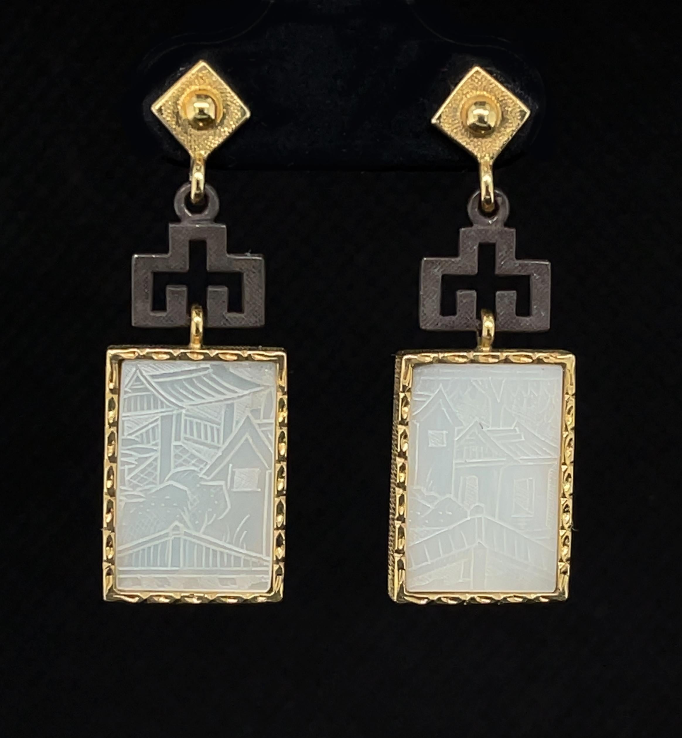 These beautiful earrings feature antique, mother-of-pearl Chinese gambling counters with motifs dating back to the 18th Century. Originally carved in China for export to Britain, these gaming counters were used like we would use poker chips. Each