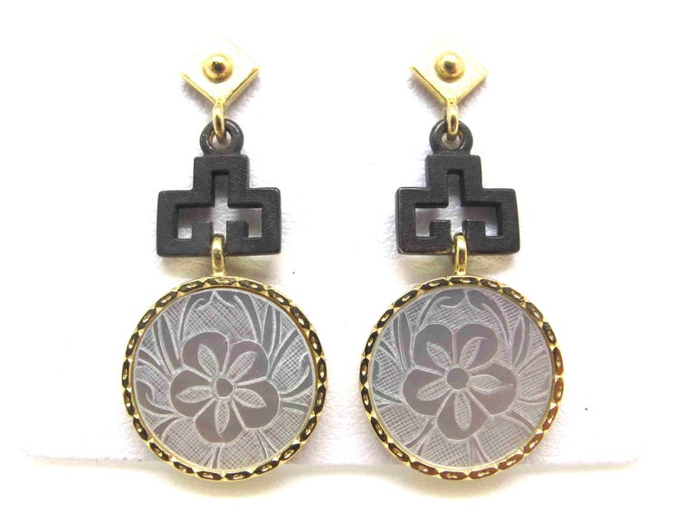 These earrings feature antique, mother-of-pearl Chinese gambling counters with motifs dating back to the 18th Century. They are original pieces that we have made in to jewelry. Originally carved in China for export to Britain, they were used like we