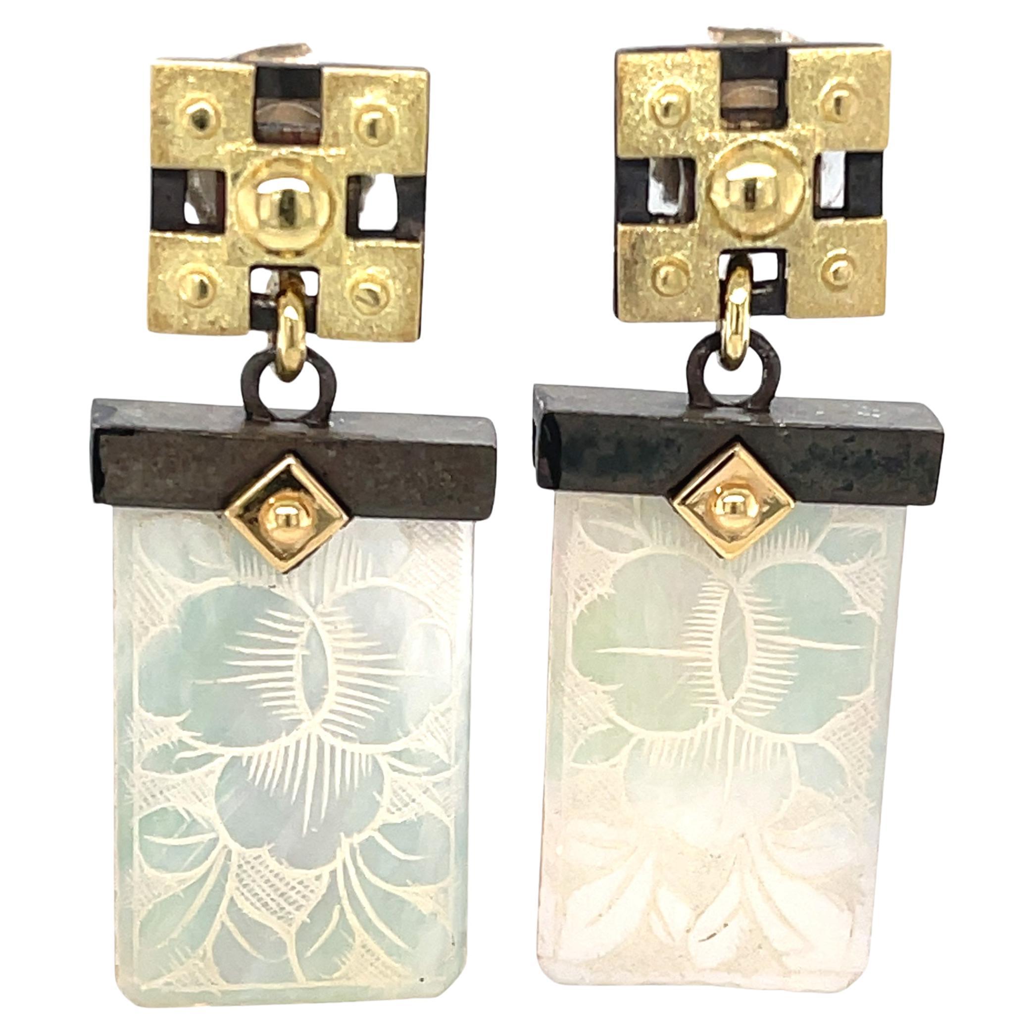 These gorgeous dangle earrings feature antique mother-of-pearl gambling counters that were hand carved in the 18th Century. The gaming counters or 