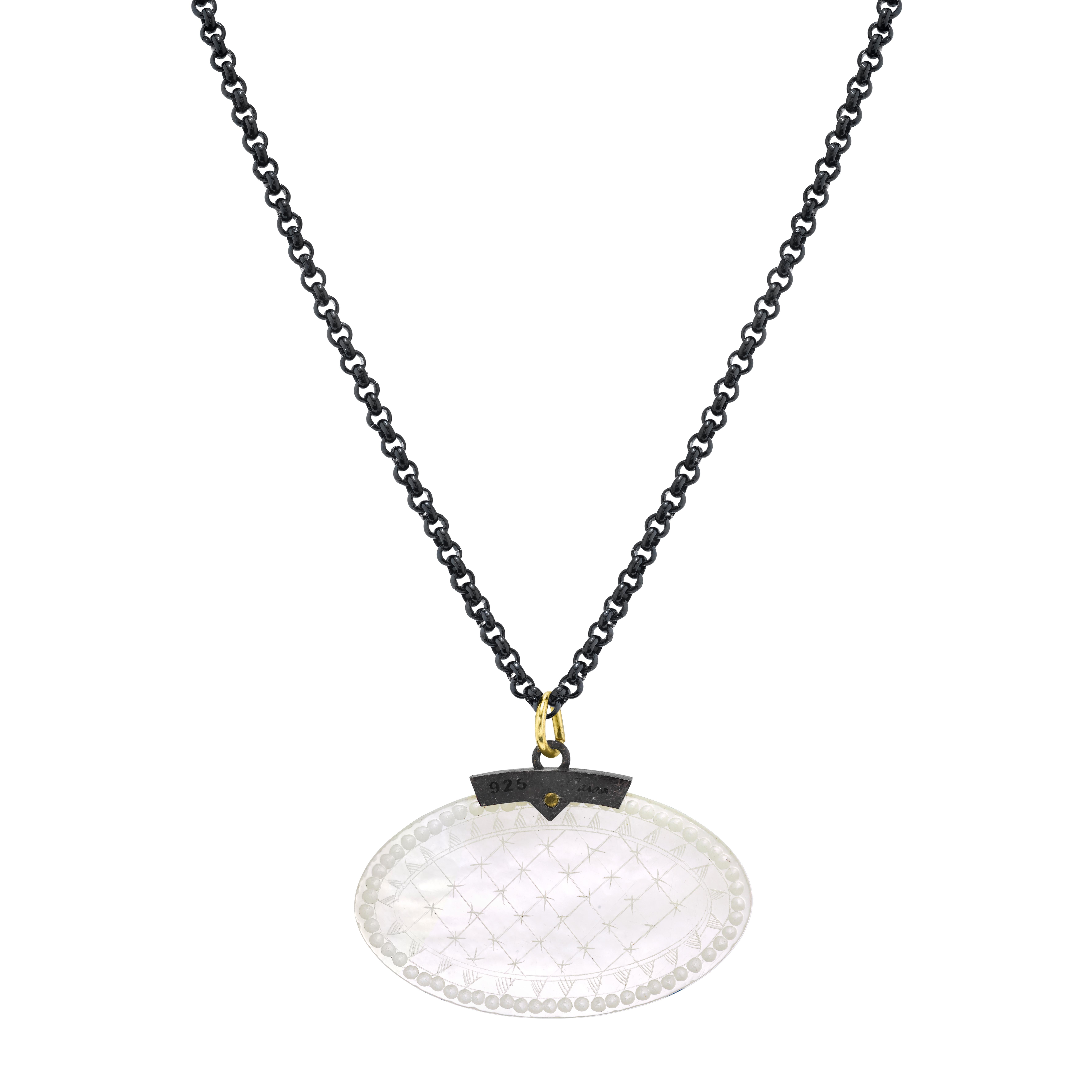 This striking necklace features an antique, mother-of-pearl Chinese gambling counter dating back to the 18th Century. The oval gaming counter is set in a striking blackened silver setting that is accented with an 18k yellow gold rivet and bail. This