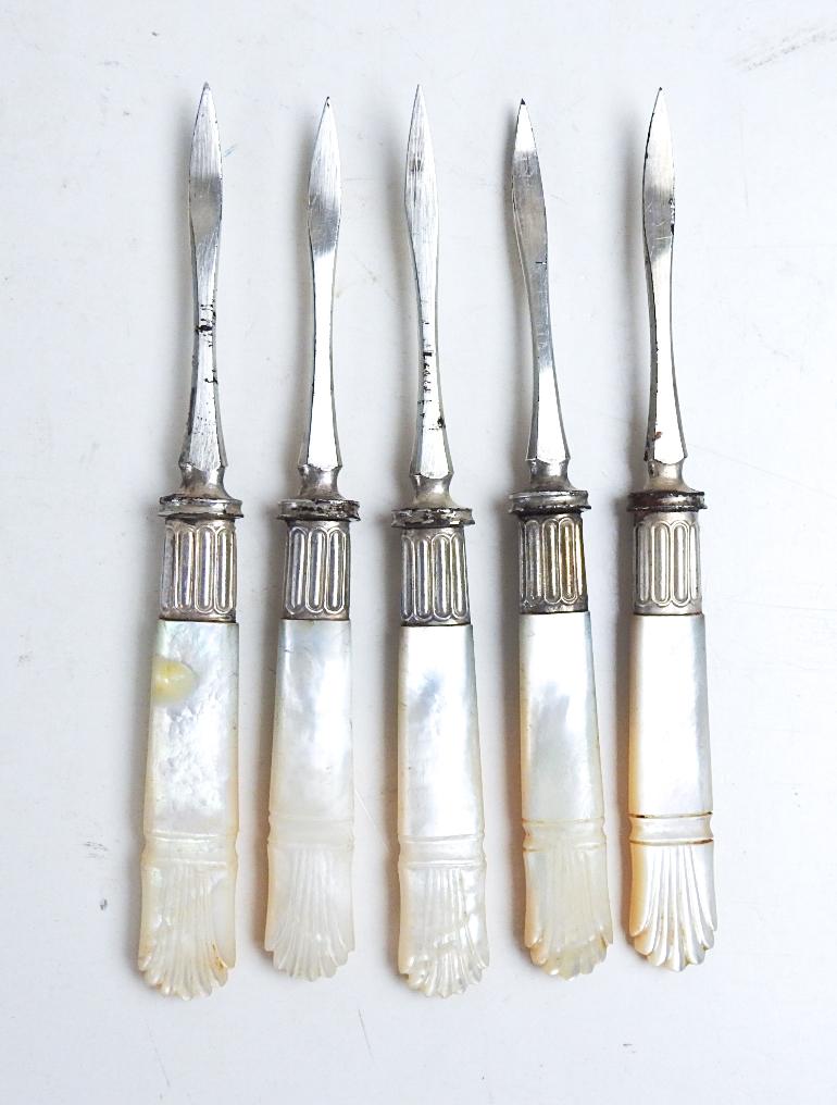 Set of 5 antique late 19th century mother of pearl carved handle nut picks with silverplate ferrule and steel picks.  Unmarked, some plating loss to picks.