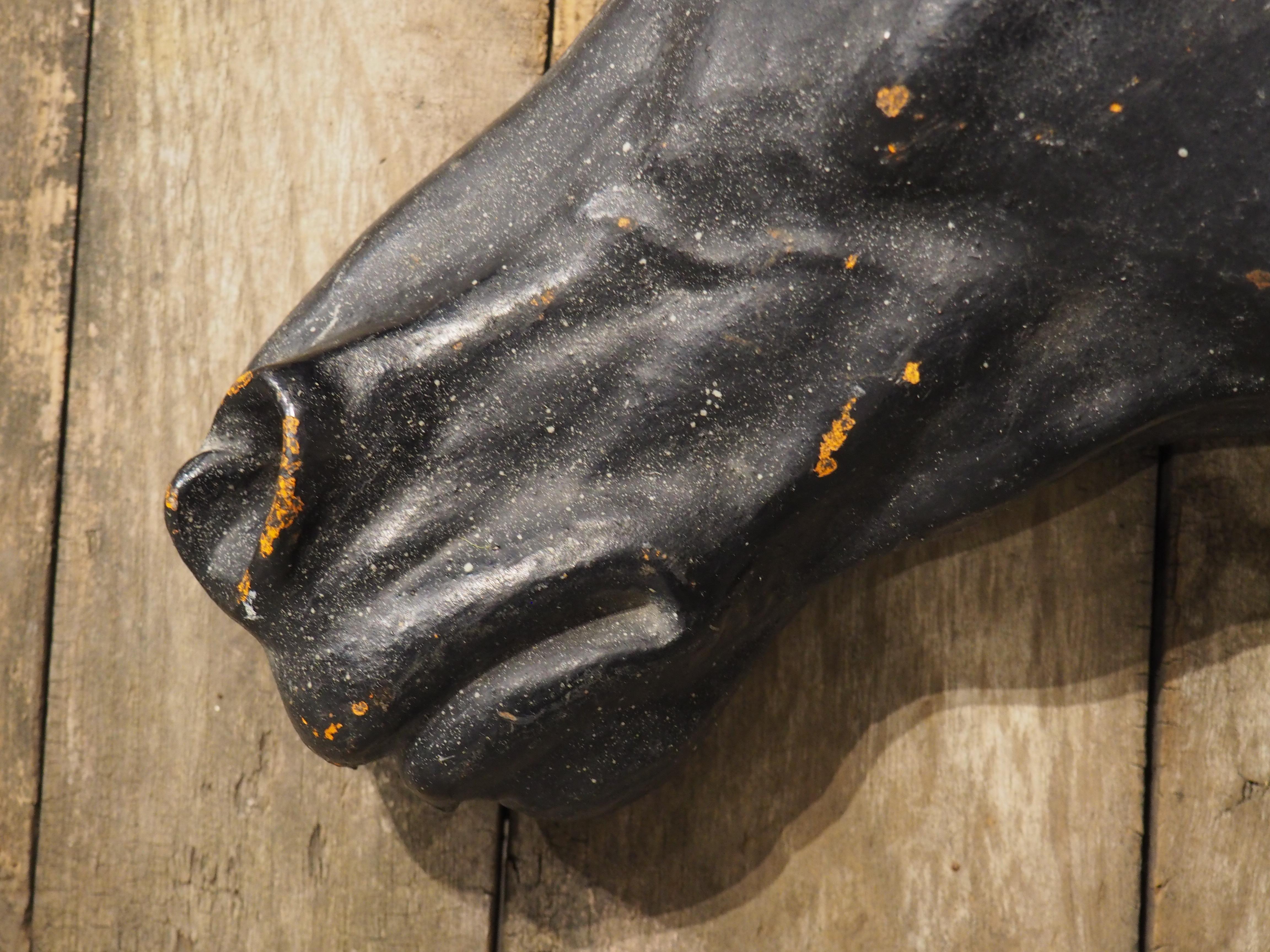 More information coming soon…

Once mounted to the wall of a stable, this painted cast iron horse head dates to circa 1880s.  The black horse head is shown in profile and affixed to a circular wooden backing comprised of six boards.