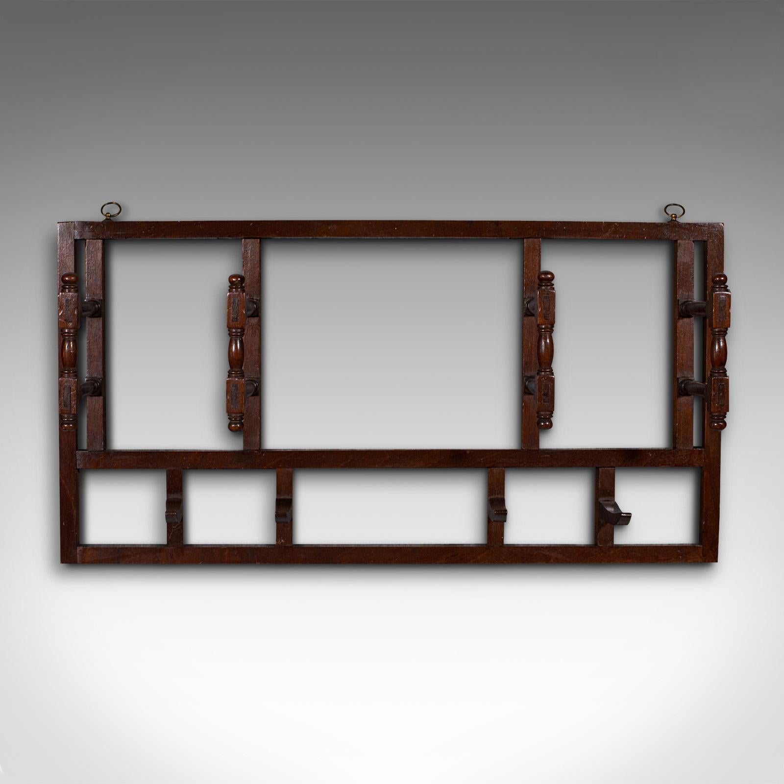 This is an antique mounted coat rack. An English, mahogany folding hallway hat and scarf hanger, dating to the Edwardian period, circa 1910.

Of ideal proportion for the smaller abode
Displays a desirable aged patina and in good order
Select