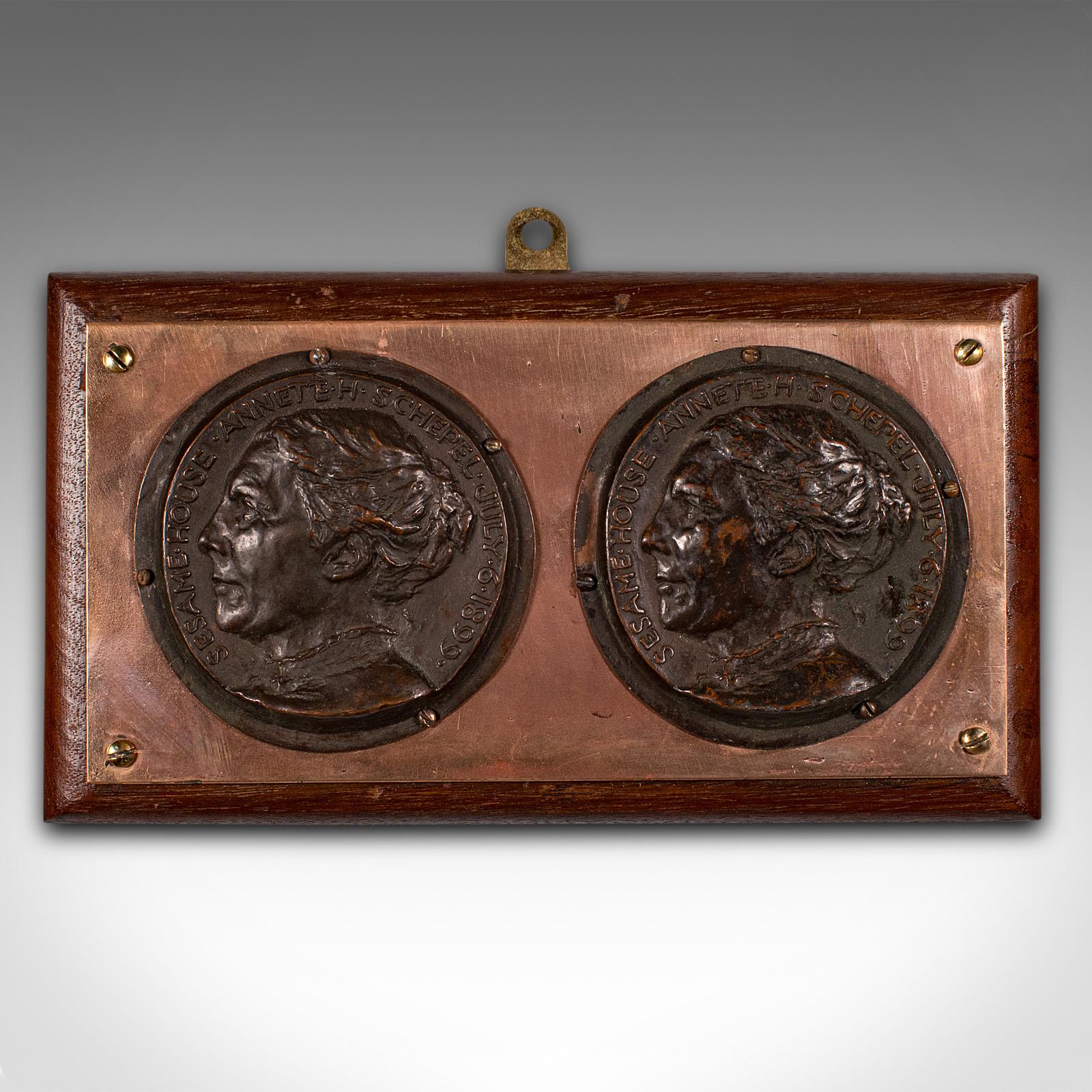 This is an antique mounted portrait plaque. An English, bronze and mahogany decorative wall panel, dating to the late Victorian period, circa 1900.

Sesame House was established in Hampstead, London in 1899 as a society to help aid the advancement