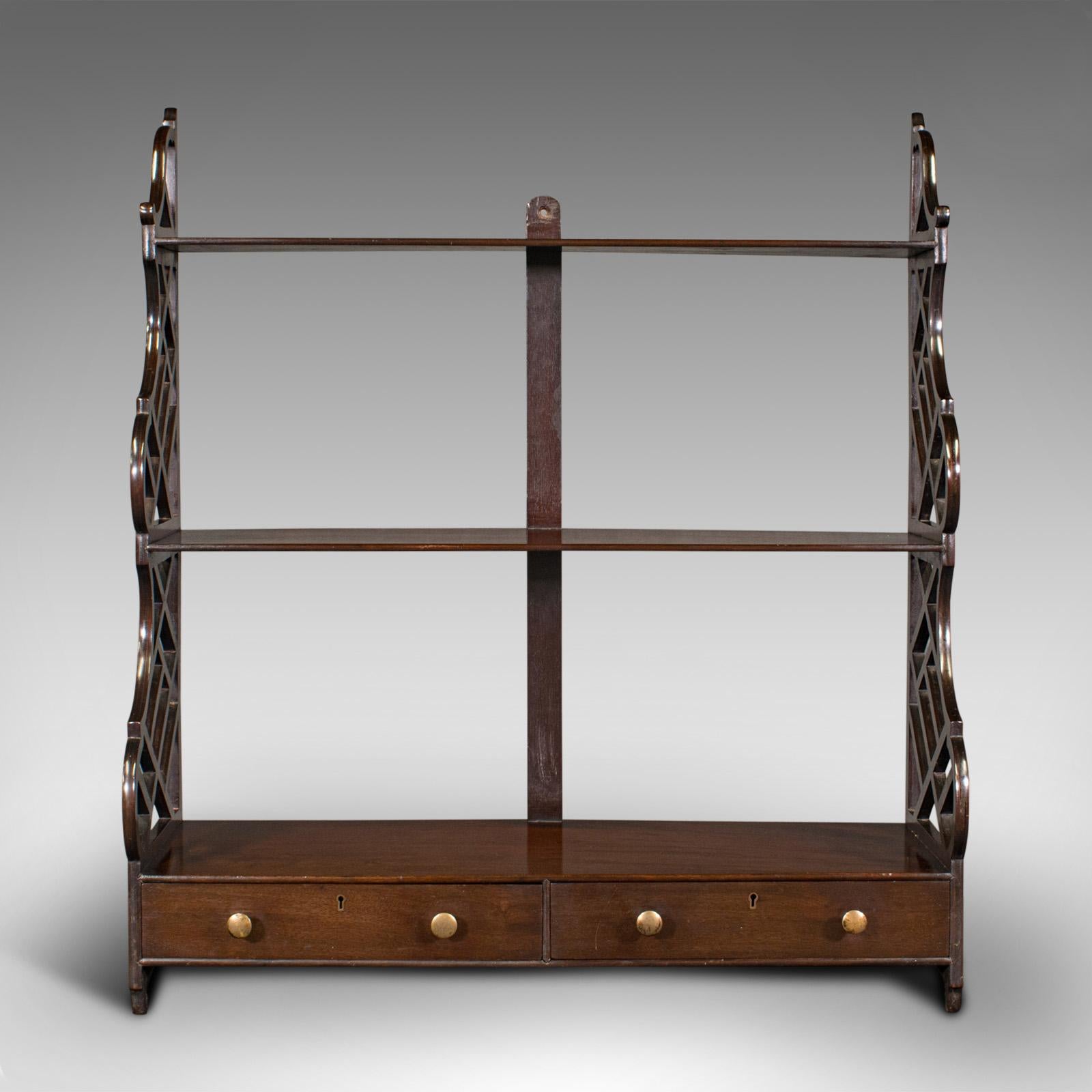 This is an antique mounted whatnot. An English, mahogany wall shelf with Chinoiserie taste, dating to the late Victorian period, circa 1900.

Attractive wall mounted display shelves with distinctive finish
Displays a desirable aged patina and in
