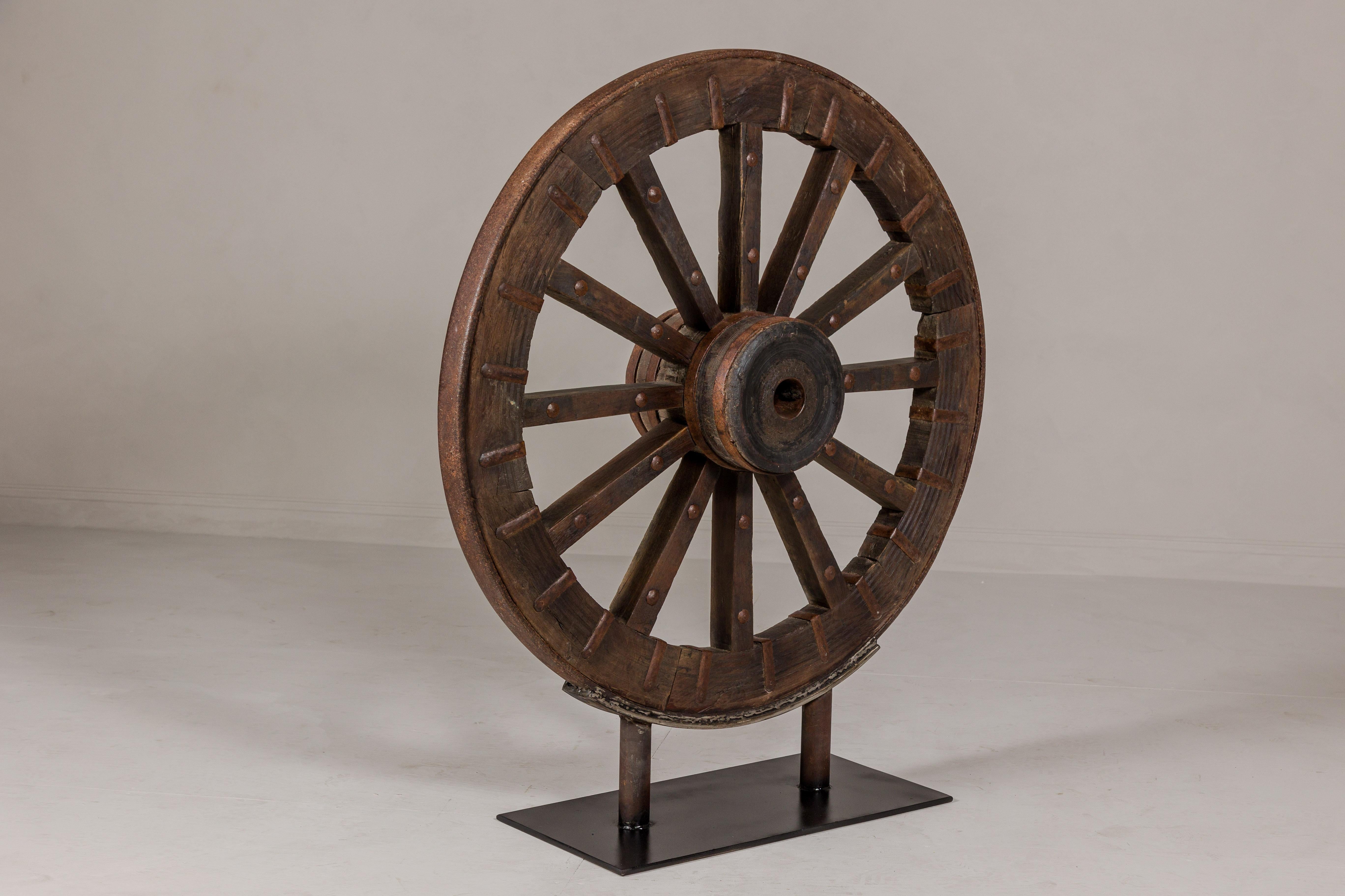 Antique Mounted Wood and Metal Wheel Welded to a Custom Metal Base For Sale 4