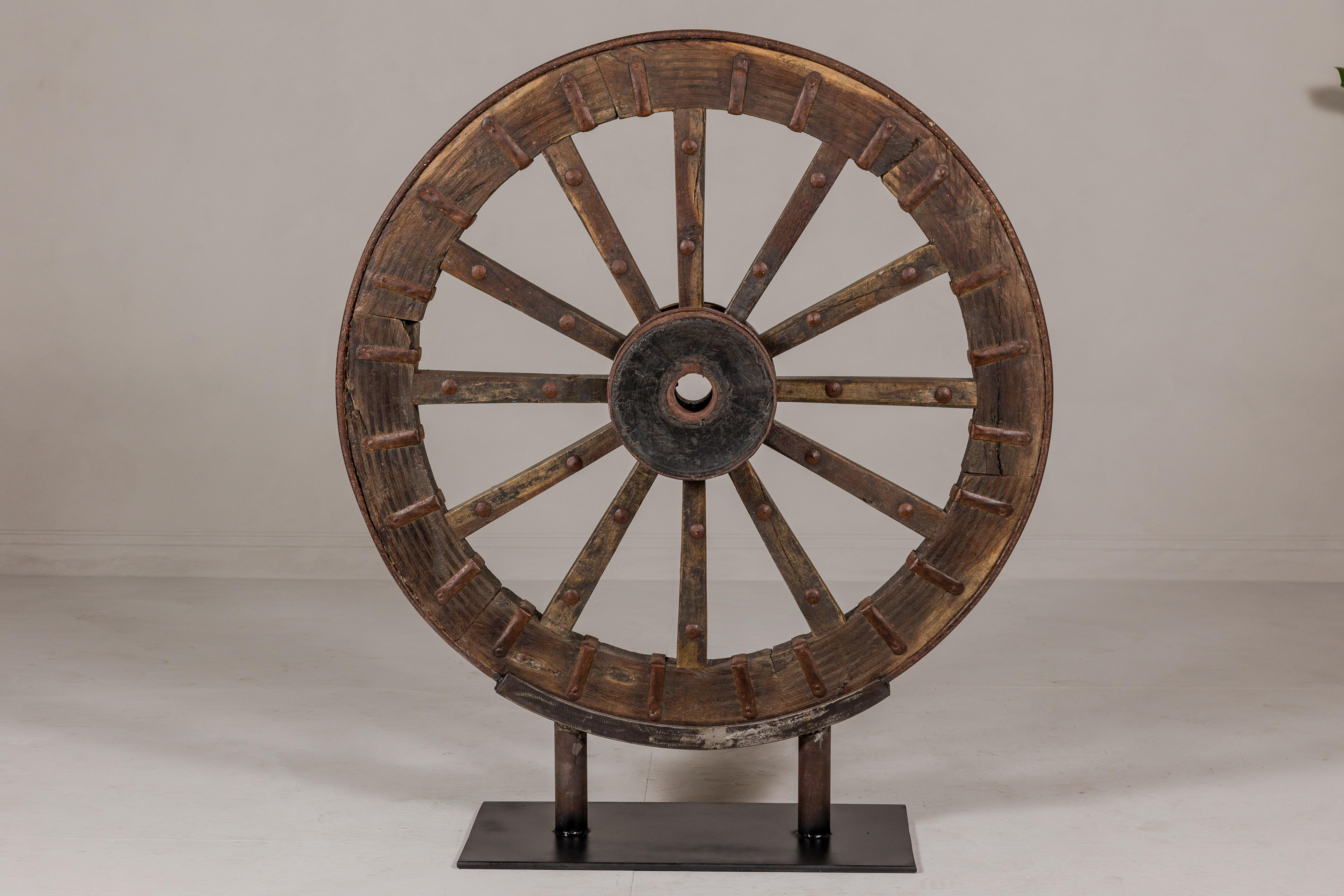 Antique Mounted Wood and Metal Wheel Welded to a Custom Metal Base For Sale 6