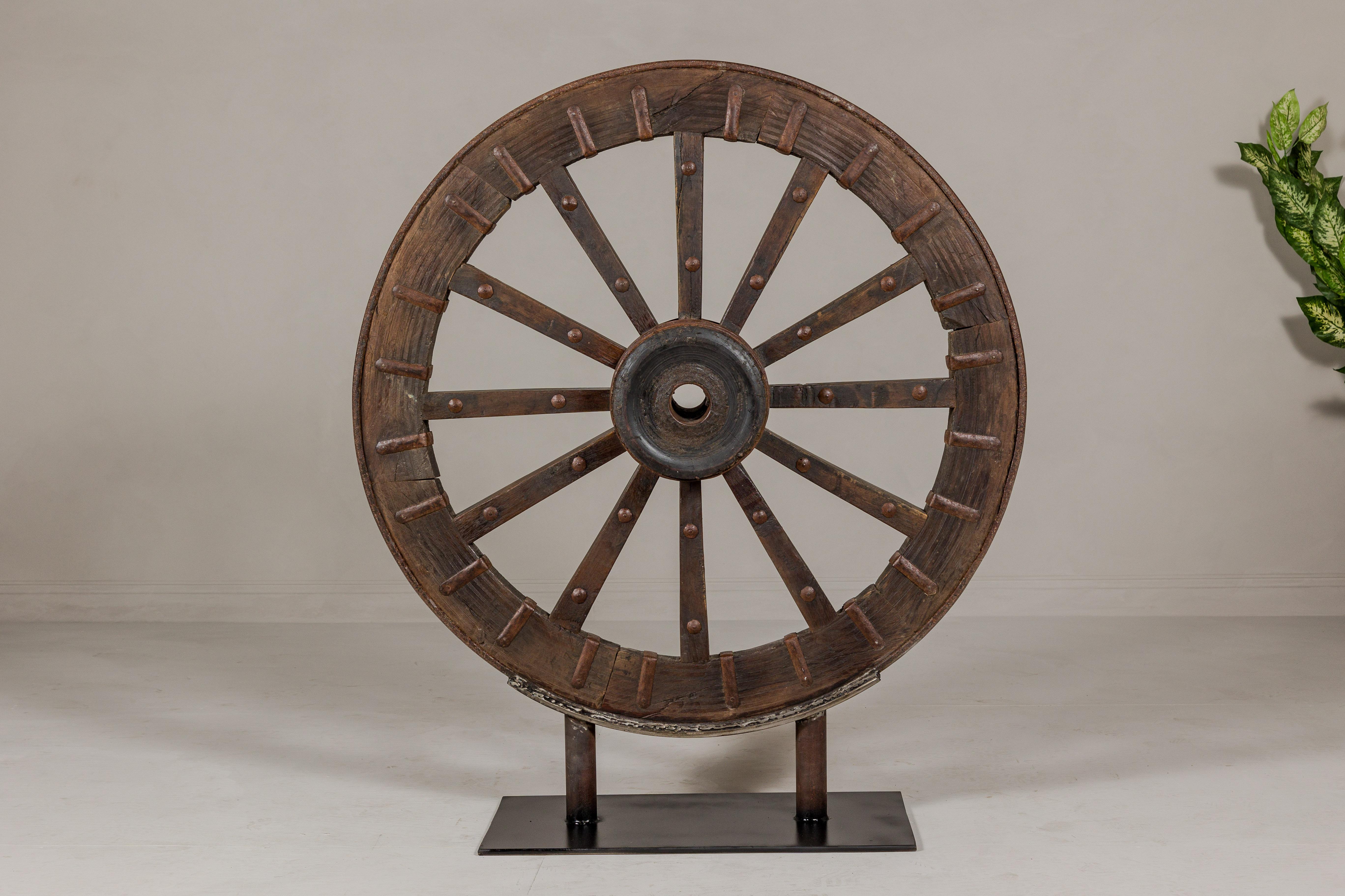 Indian Antique Mounted Wood and Metal Wheel Welded to a Custom Metal Base For Sale