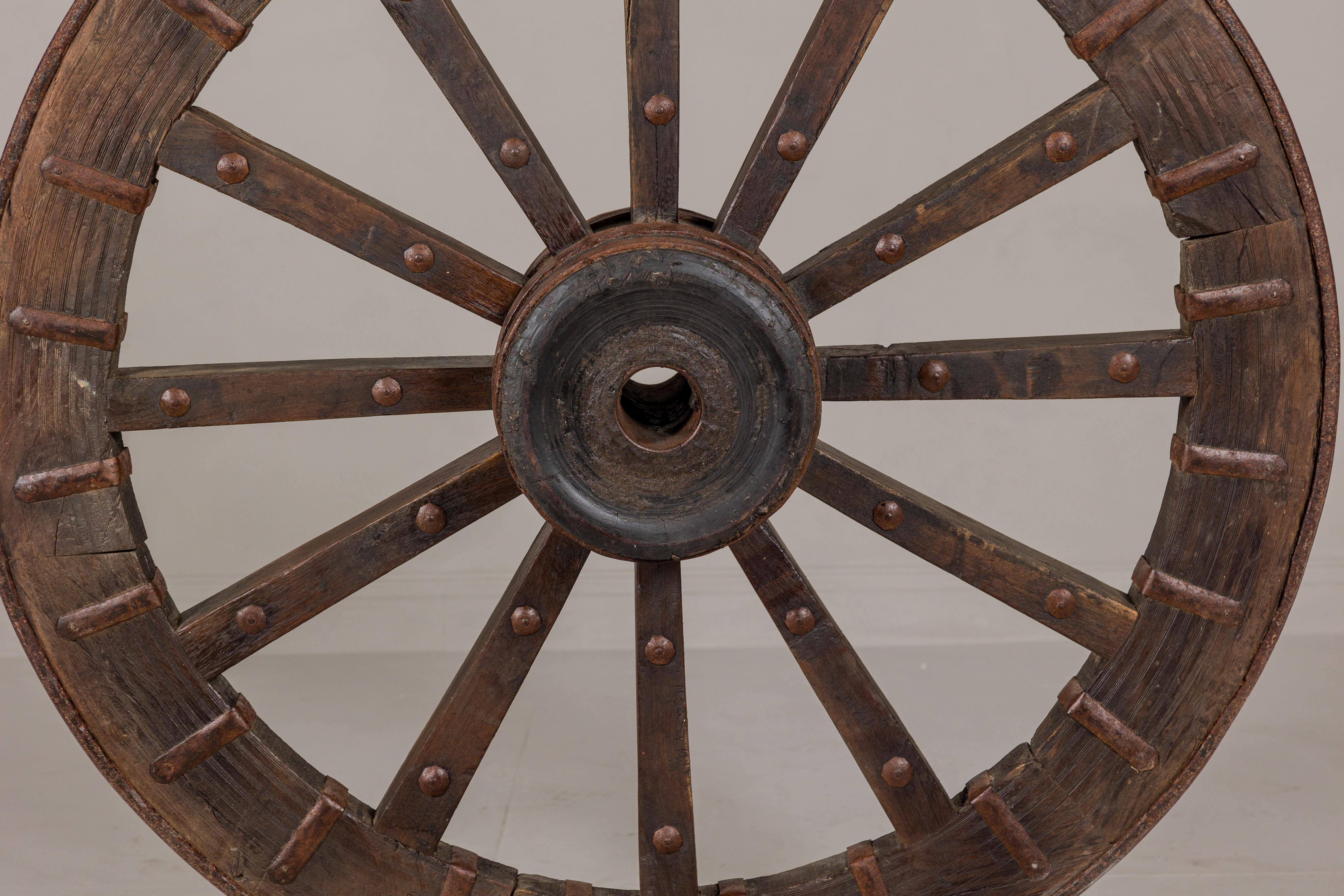 19th Century Antique Mounted Wood and Metal Wheel Welded to a Custom Metal Base For Sale