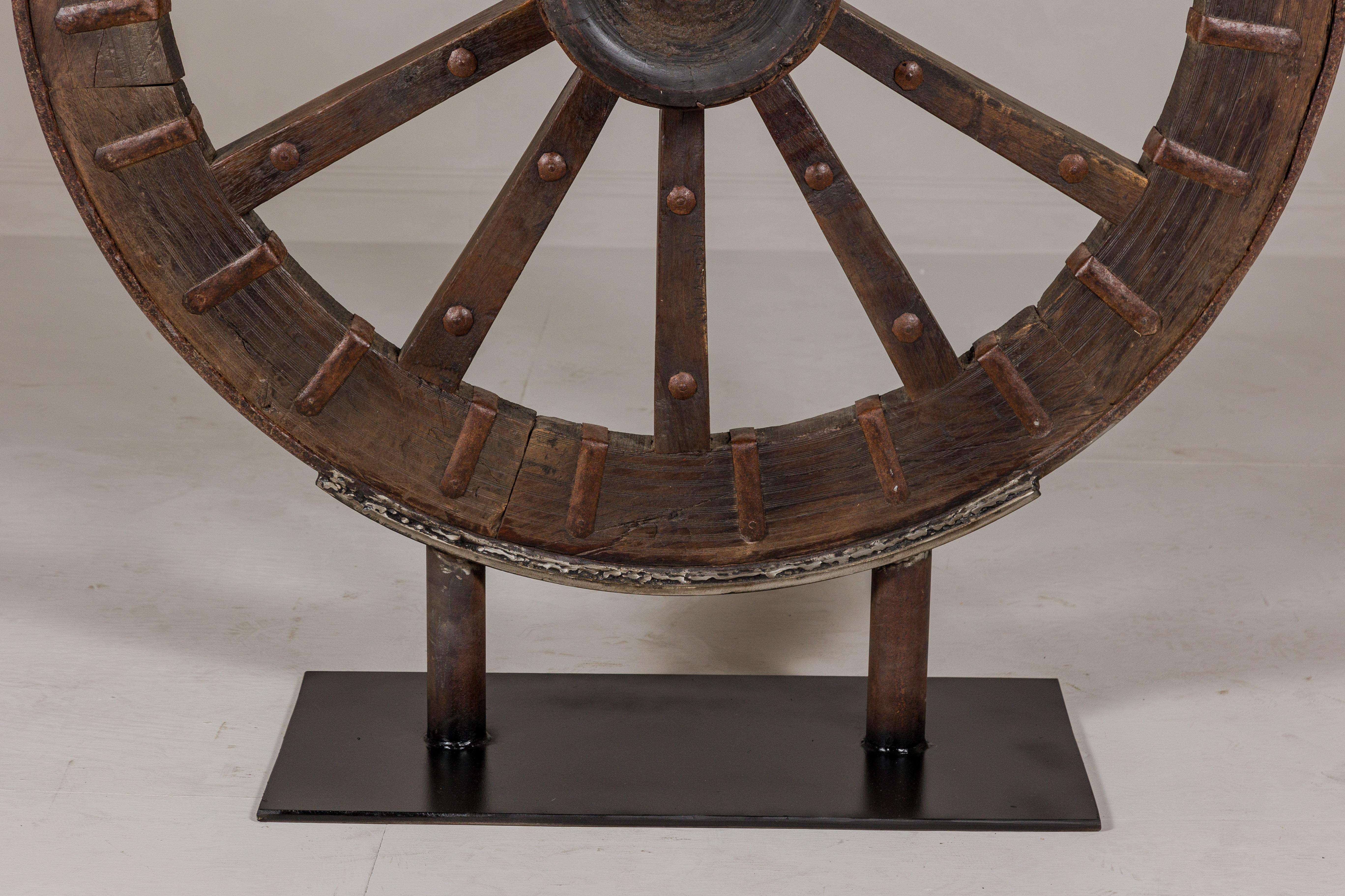 Antique Mounted Wood and Metal Wheel Welded to a Custom Metal Base For Sale 1