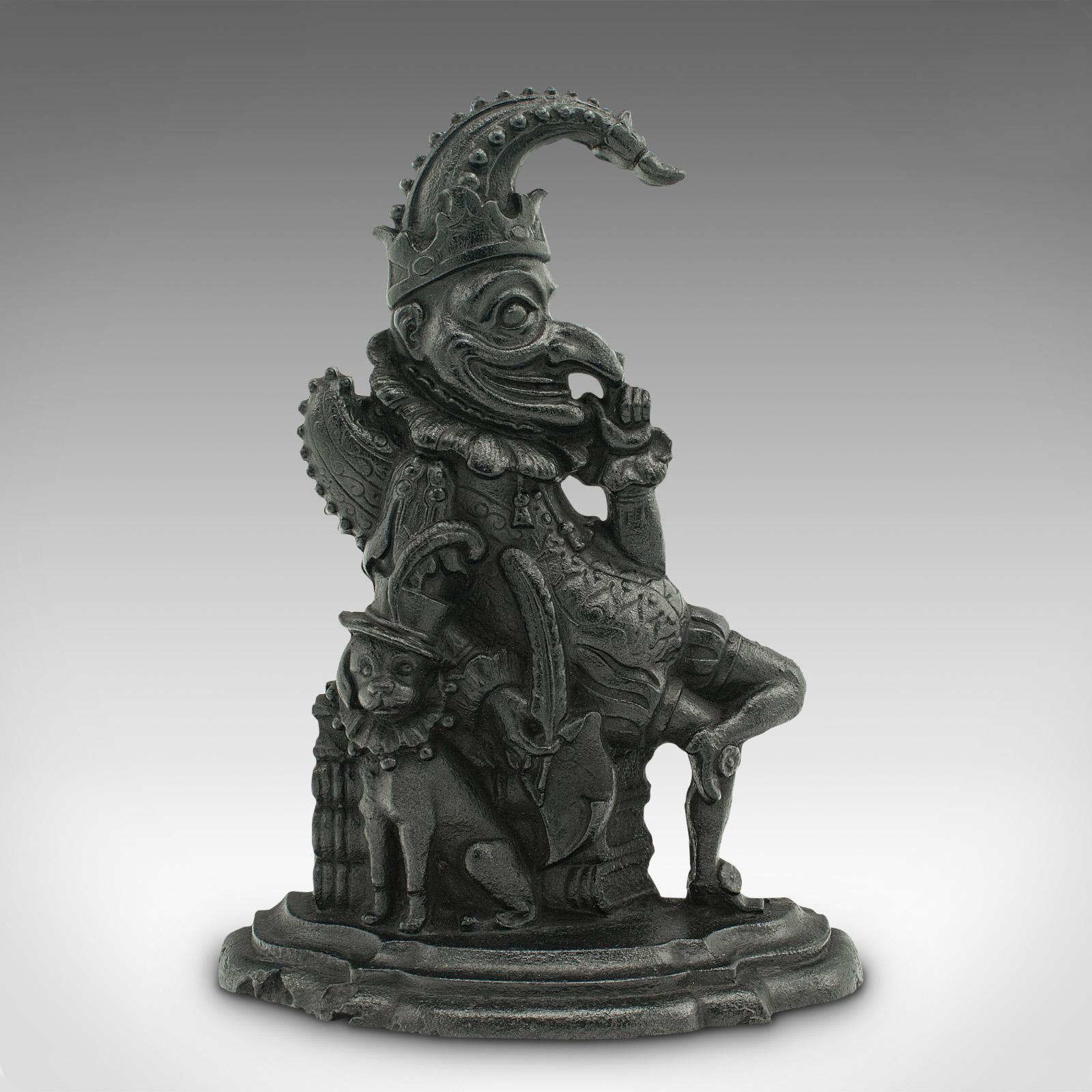 This is an antique Mr. Punch doorstop. An English, cast iron figurative door keeper, dating to the Victorian period, circa 1880.

Originating in the commedia dell'arte of 16th century Italy, Punchinello came to be known as Mr. Punch, his first