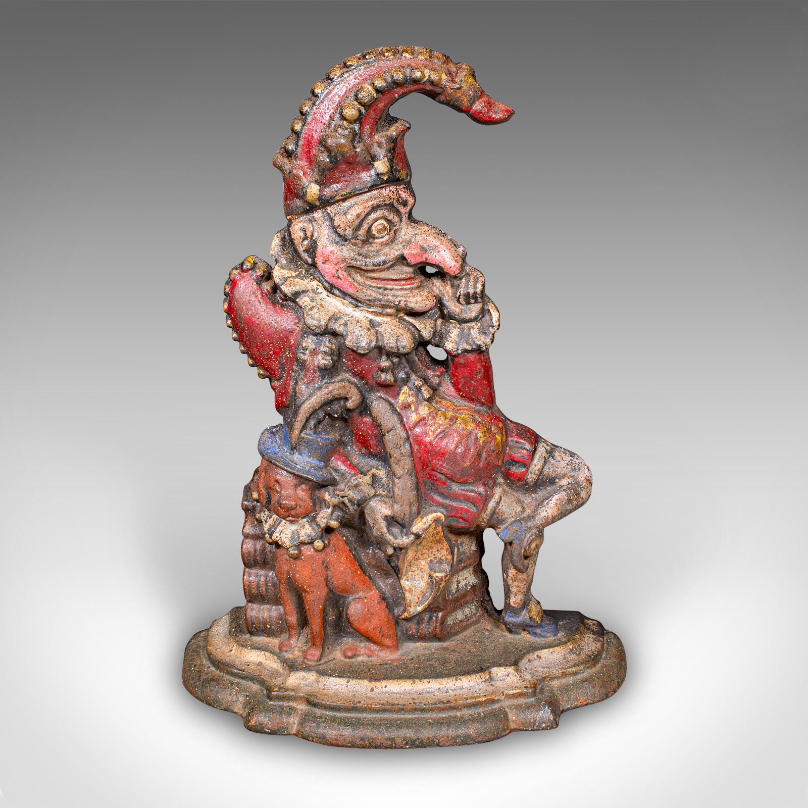 This is a fascinating antique Mr Punch doorstop. An English, painted cast iron figural door keeper, dating to the Victorian period, circa 1880. A colourful representation of the iconic puppet character, adding a visual flourish to any