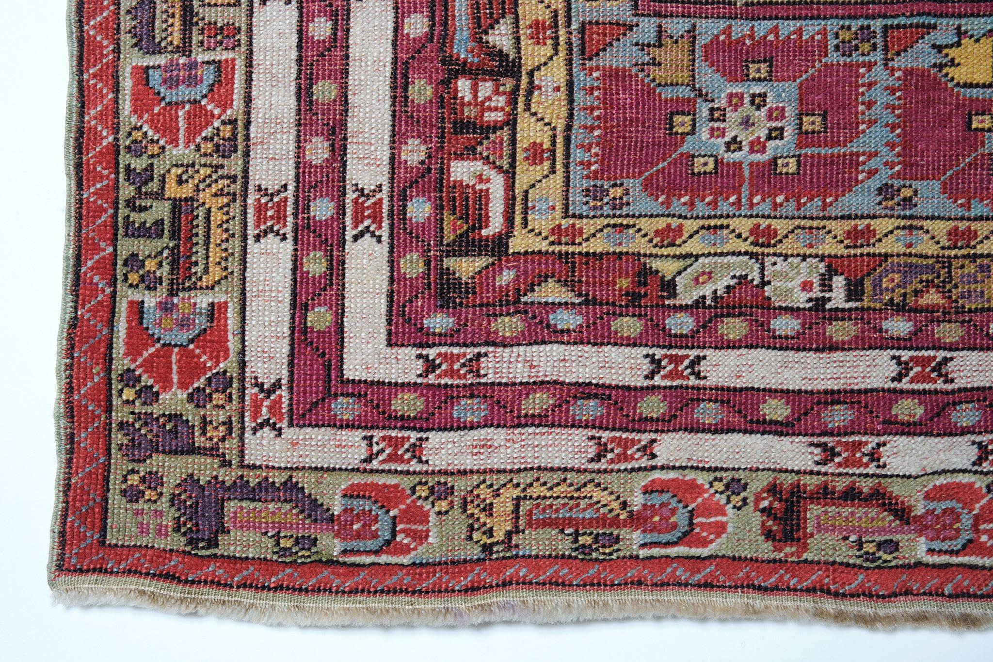 This is an antique Mucur rug from Central Anatolia, the Kirsehir region with a red background, good condition, and beautiful color composition. 

The town of Mudjar (or Mucur) is about twenty miles southeast of Kirsehir. The area has a long