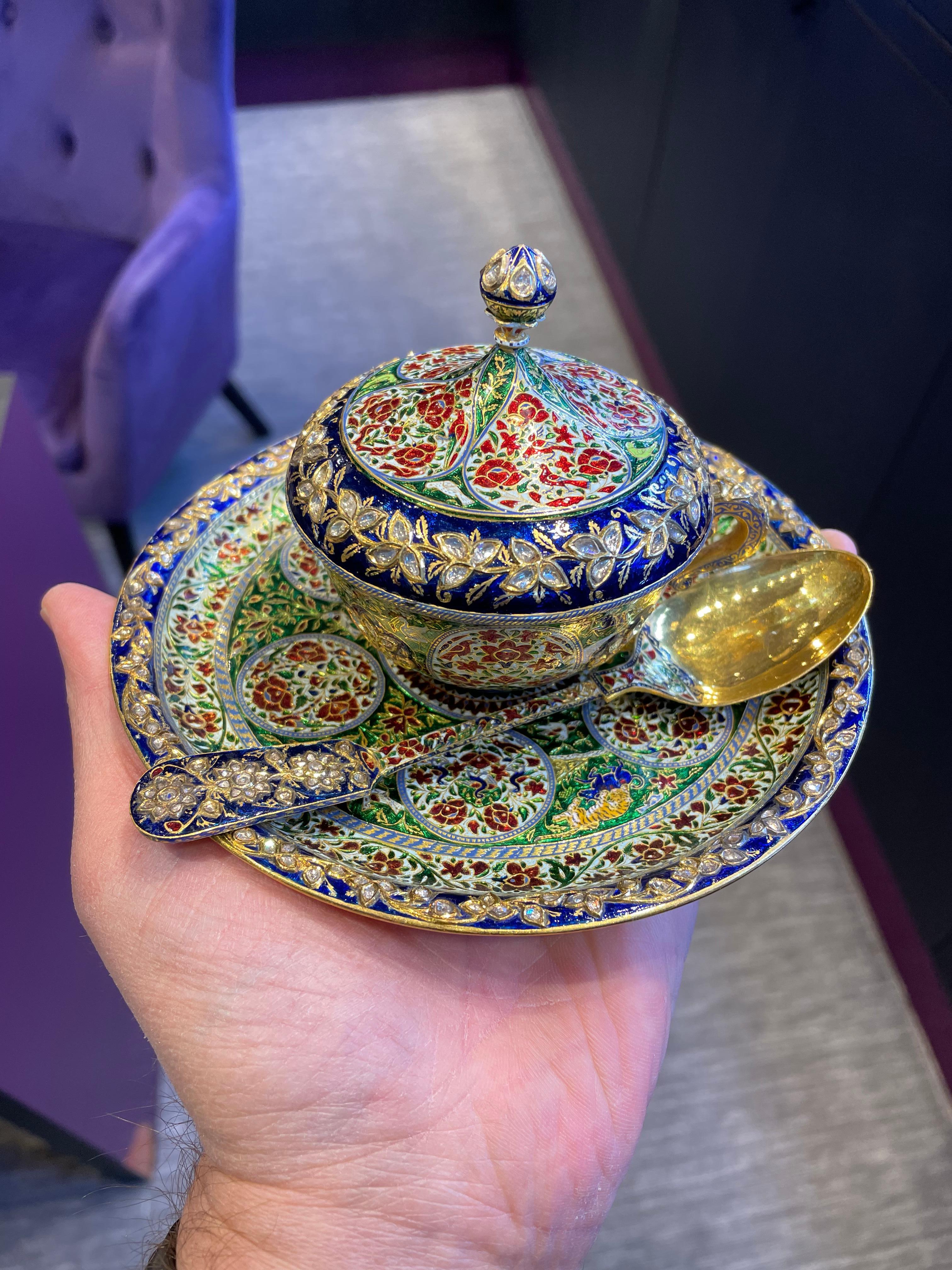 Antique Mughal Indian Enamel and Diamond Cup Saucer & Spoon Set 

A 200+ year old masterpiece: Incredible enamel on gold tea cup, saucer, and spoon. Set with rose cut diamonds. 
The epitome of Mughal extravagance! 

Measurements: 
Spoon: 5.5