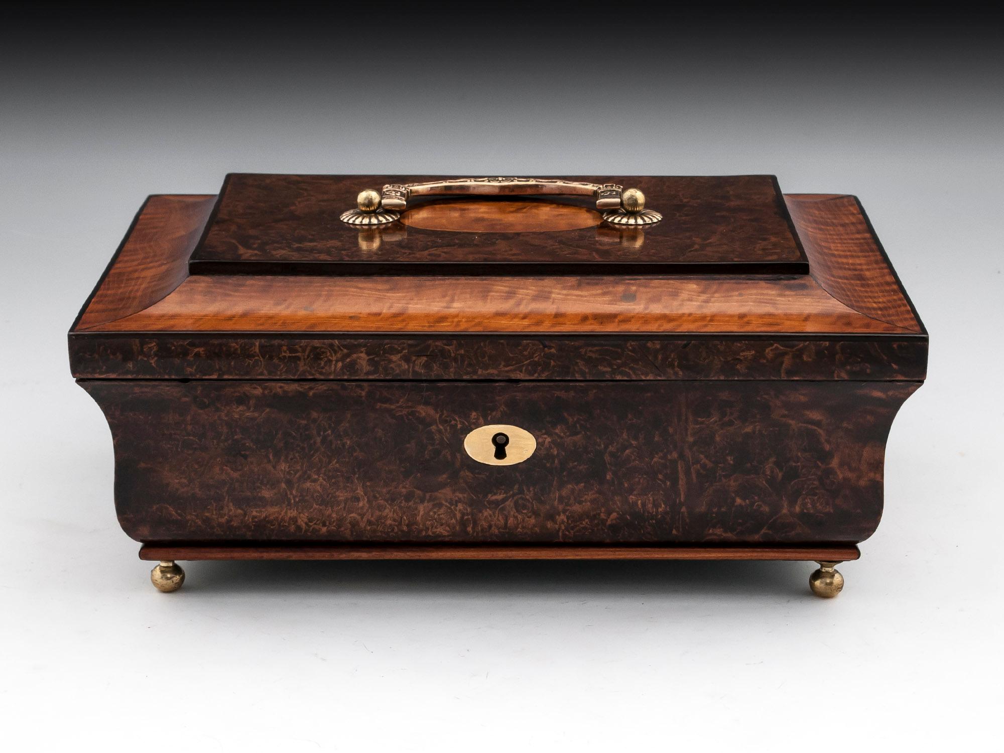 Antique Jewelry box veneered in beautiful mulberry and satinwood. With an engraved brass carry handle, escutcheon and standing on four small brass ball feet. 

The interior of this sweet jewelry box is lined in green velvet and silk paper, and