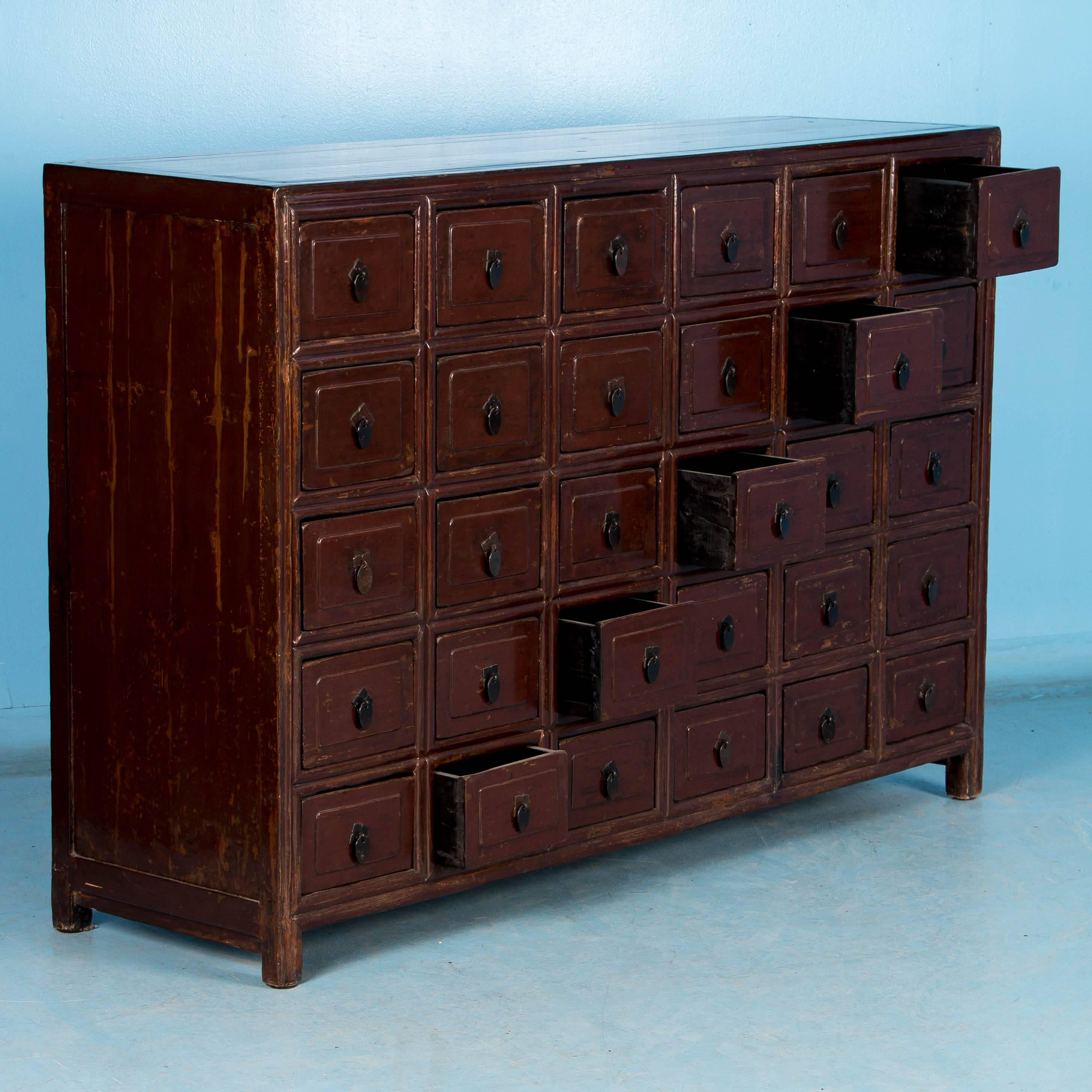 There is something visually mezmerizing about an old apothecary and this unique Chinese cabinet from the late 1800's is no execption. Each of the 30 drawers is paneled and has a functioning pull, and the drawers slide smoothly. The rich deep brown