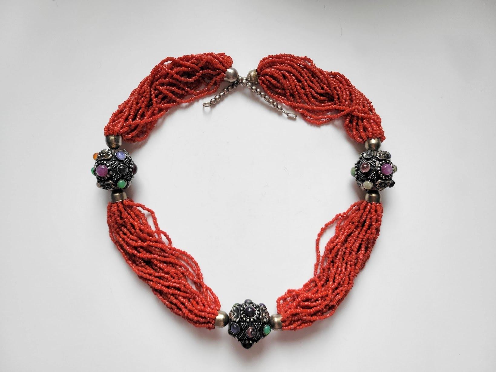 Behold this exquisite 24-strand necklace crafted with coral and silver, originating from Yemen in the heart of the Middle East. Measuring an impressive 27.5 inches, the necklace is a true spectacle. The delicate coral beads, ranging from 1.5 to 4mm,