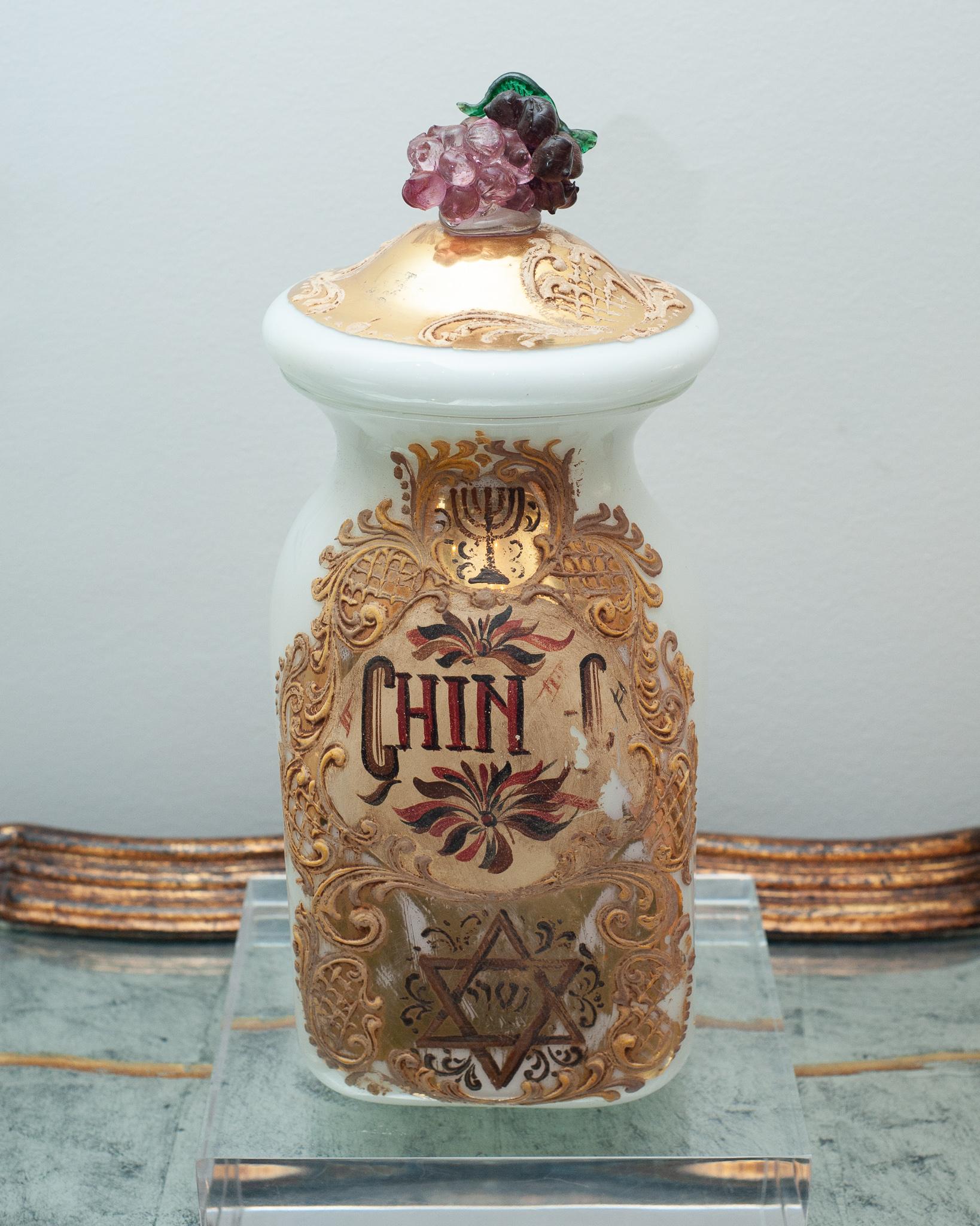 A beautiful large antique Italian Murano glass pharmacy / apothecary canister with lid. Elaborately hand-painted and gilt on white Murano glass, featuring Star of David motif and glass cluster of grapes on lid.