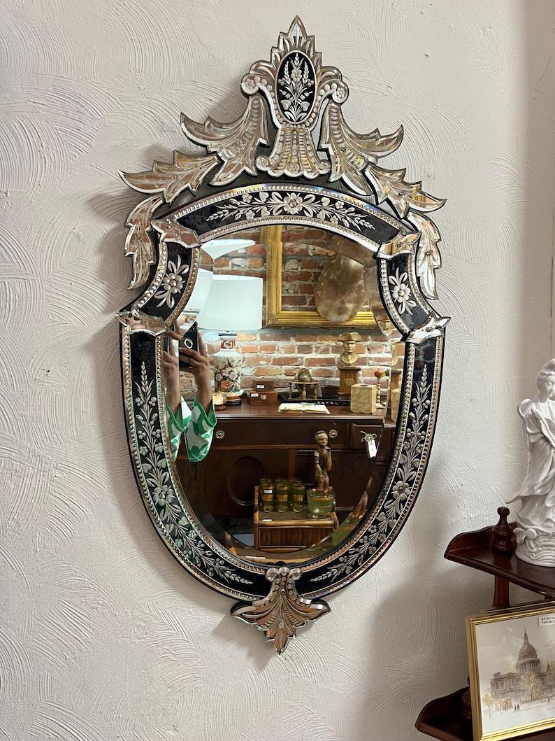 This stunning antique Venetian-style mirror, stamped “M.R. & Co. Made in Paris,” is a testament to fine craftsmanship, likely dating back to the late 19th or early 20th century. Acquired from a California mansion that had an impressive 50 mirrors