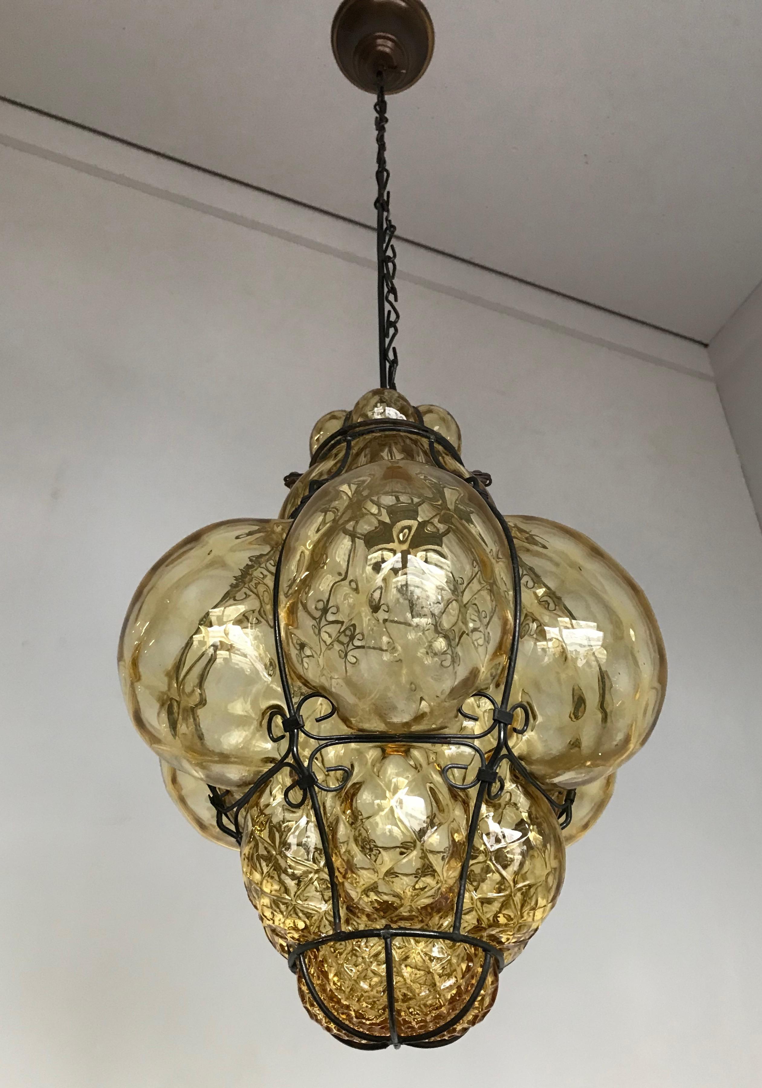 Early 20th century, Italian craftsmanship pendant. 

This stylish single light pendant is beautiful in shape and the mouth blown, bronze tinted glass is in excellent condition. It comes with a chain and canopy which guarantees easy height