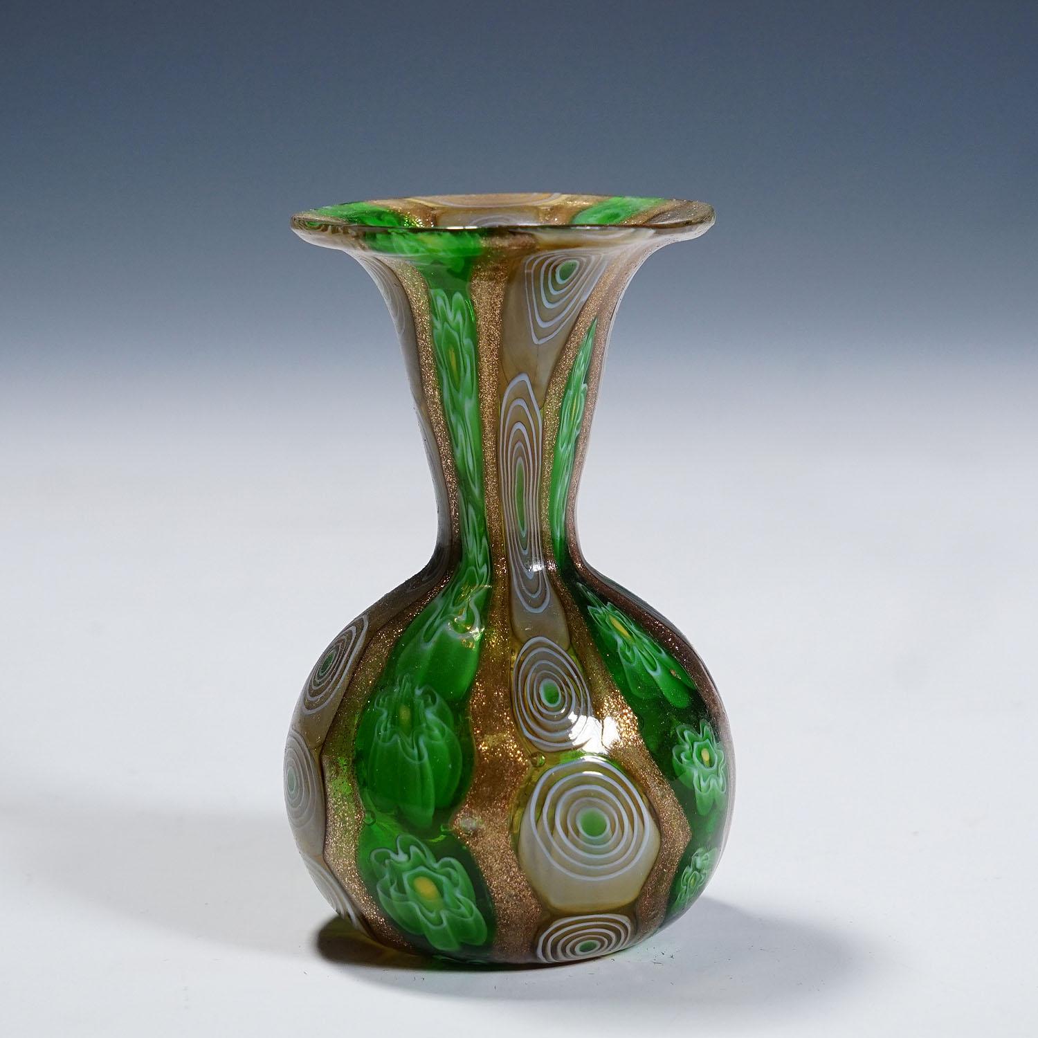 Antique Murrine Vase with Aventurine, Fratelli Toso Murano ca. 1920s

A rare millefiori murrine glass vase manufactured by Vetreria Fratelli Toso, Murano around 1920. Made of polychrome murrines in green, brown and white which were melted together