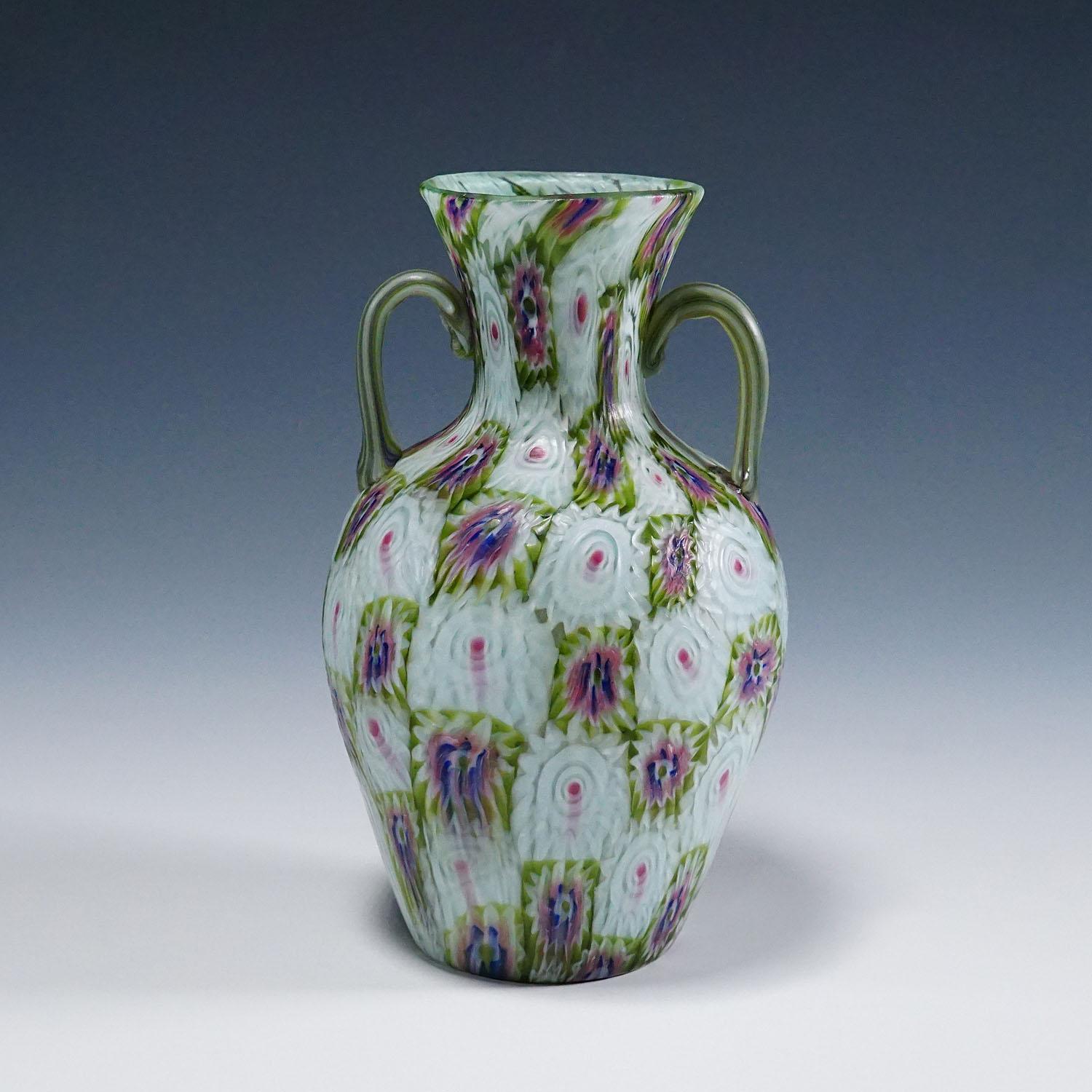 Antique Murrine Vase with Handles, Fratelli Toso Murano ca. 1920s
Item e7093
A large murrine glass vase manufactured by Vetreria Fratelli Toso, Murano around 1920. Made of polychrome murrines in blue, green, purple and white which were melted