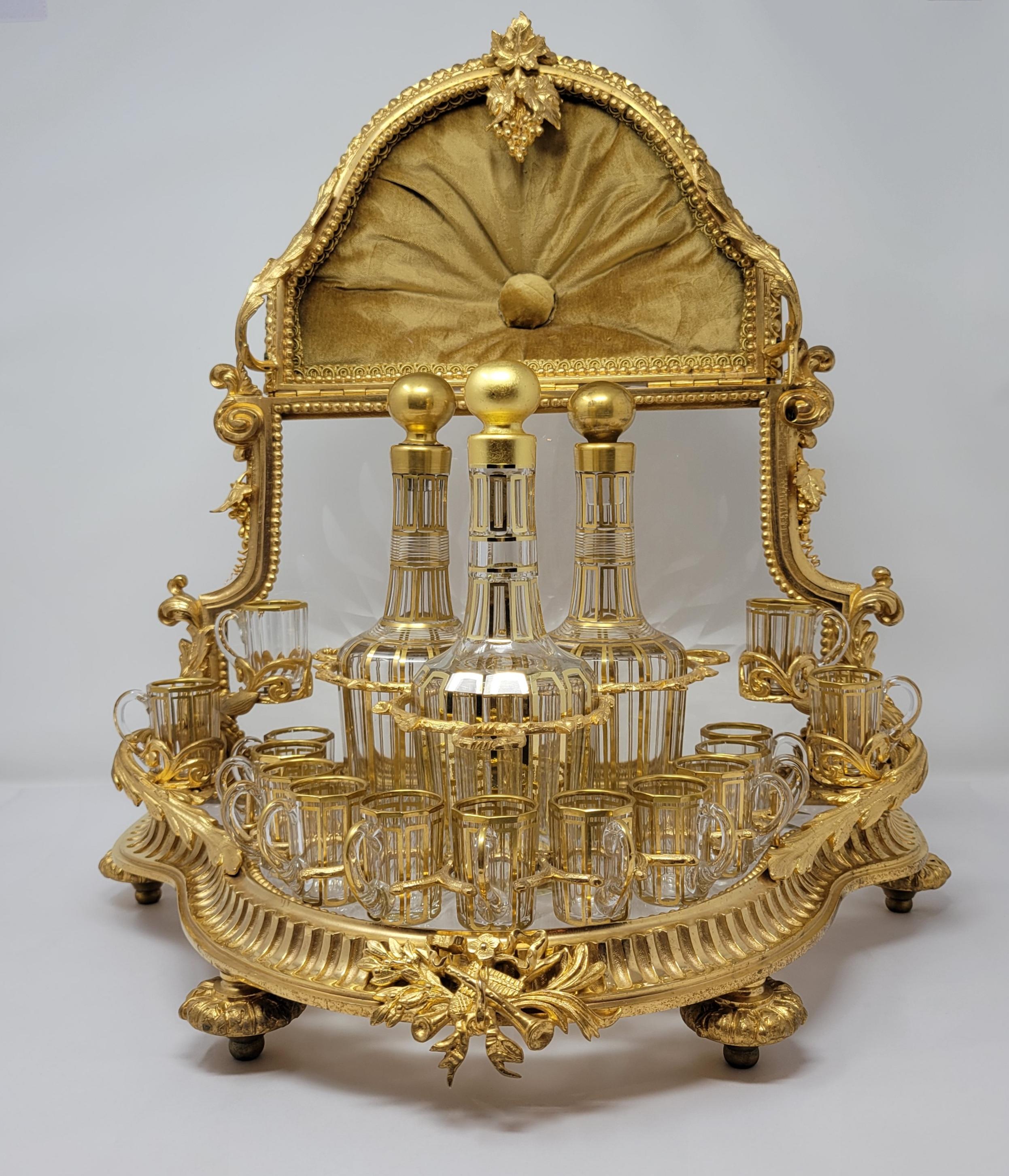 Museum Quality Antique 19th Century French Baccarat Crystal and Ormolu Cave à Liqueur with Fitted Interior that includes 3 Gold-Leaf Cut Crystal Liqueur Bottles and 15 Gold-Leaf Cut Crystal Liqueur Glasses.  Exceptional condition. The glass on the