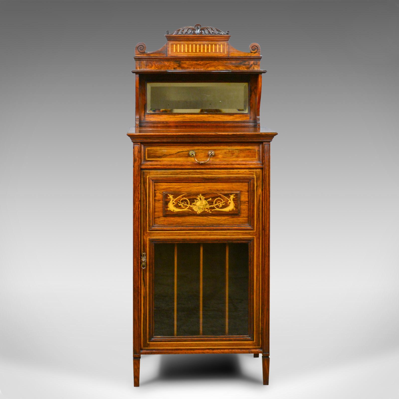This is an antique music cabinet in rosewood. An English, Victorian, mirror back cupboard dating to the late 19th century, circa 1880.

Exceptional grain interest and color in the rosewood cabinetry
Displaying a desirable aged patina
Classical