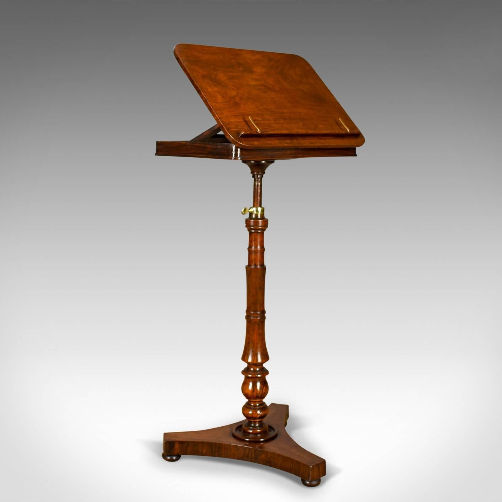 This is an antique music stand, an English, Regency adjustable, rosewood lectern dating to circa 1820.

Delightful color and tone to the rosewood
Well figured, displaying grain interest with a desirable aged patina
Fully adjustable height and